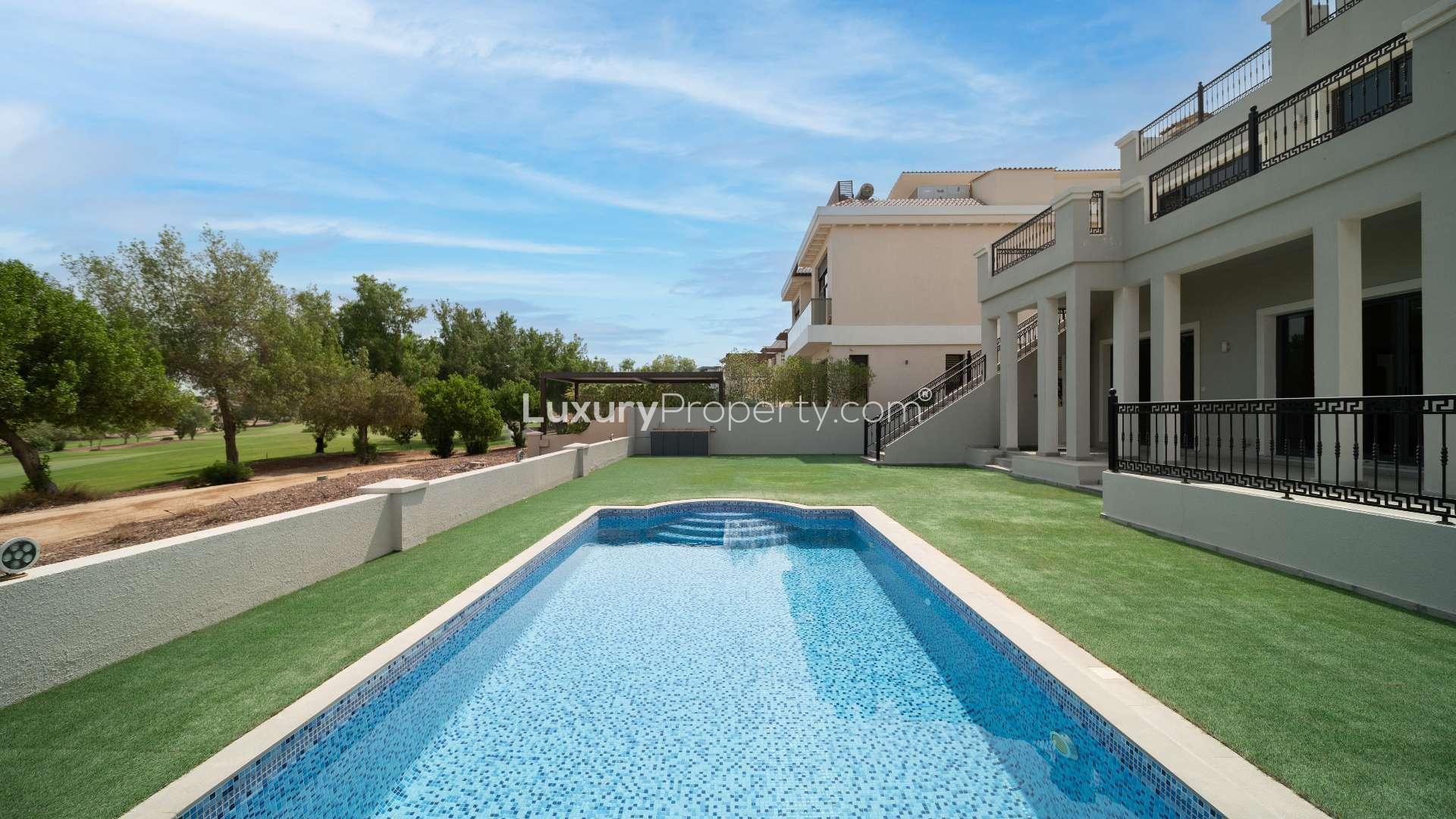 Bright living room with marble floors and fireplace in Jumeirah Golf Estates villa