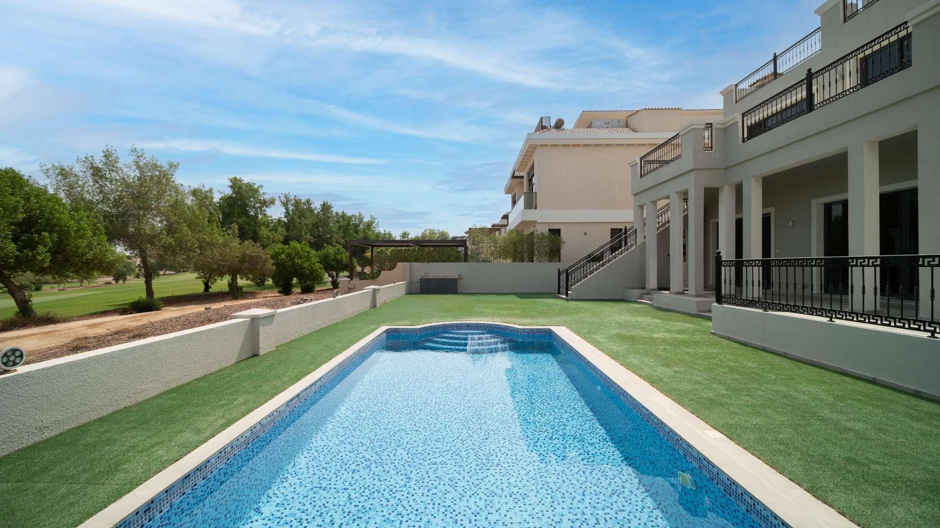 Bright living room with marble floors and fireplace in Jumeirah Golf Estates villa