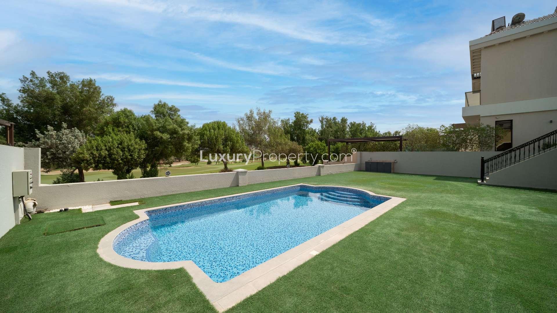 Outdoor pool area of custom-built villa in Jumeirah Golf Estates, Earth community