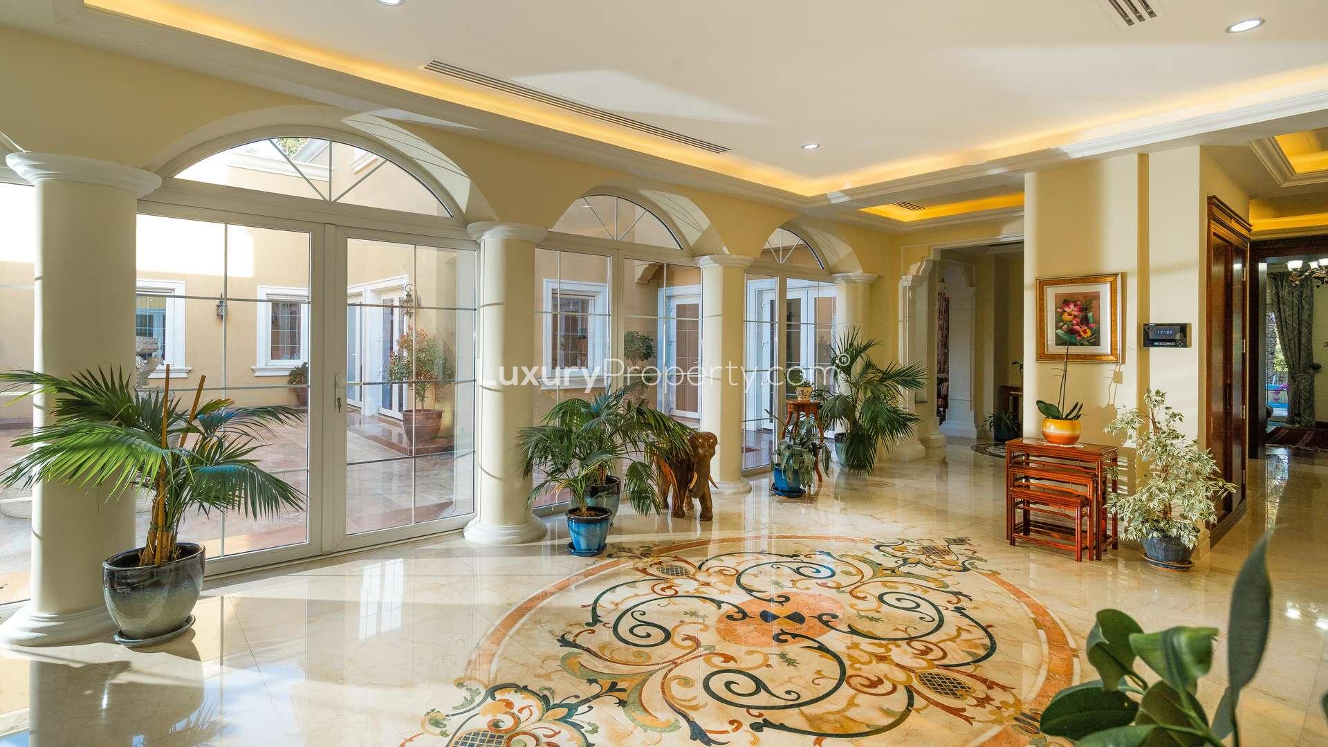 Luxurious villa interior with elegant decor, marble floors, and large windows in Arabian Ranches