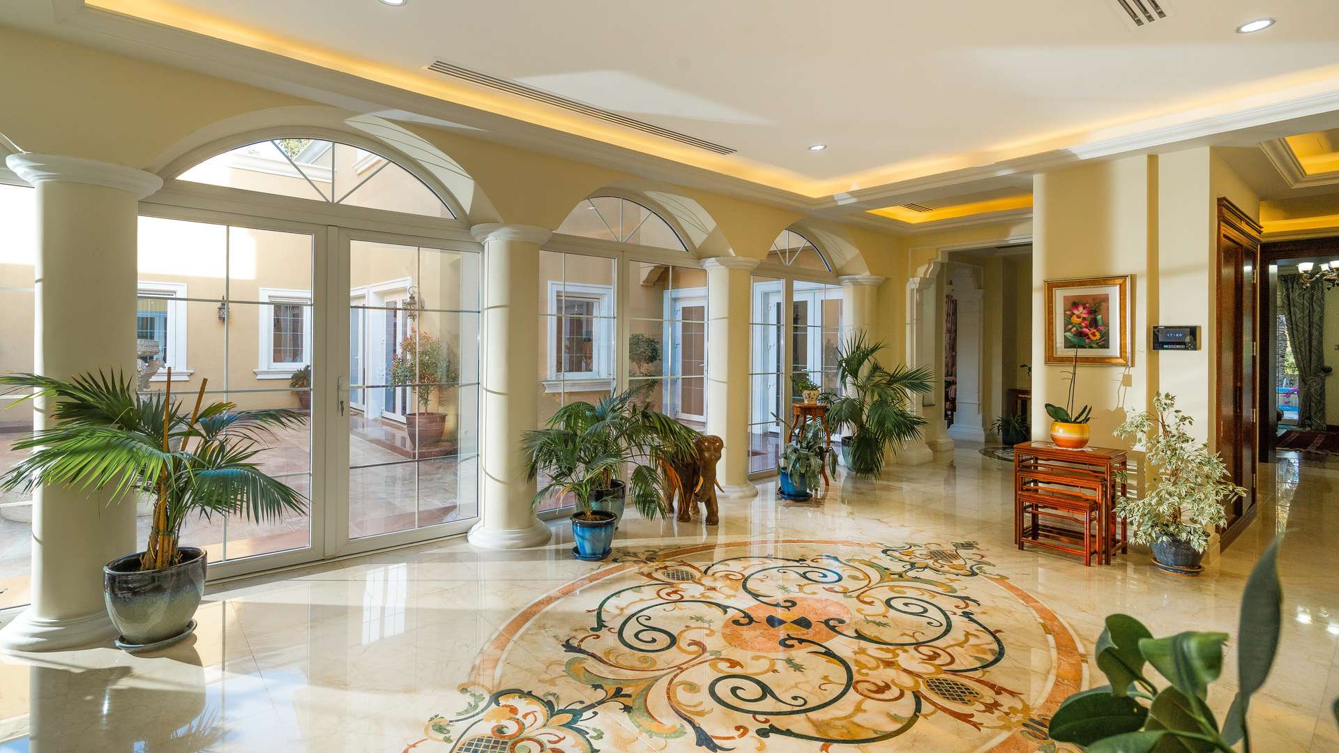 Luxurious villa interior with elegant decor, marble floors, and large windows in Arabian Ranches