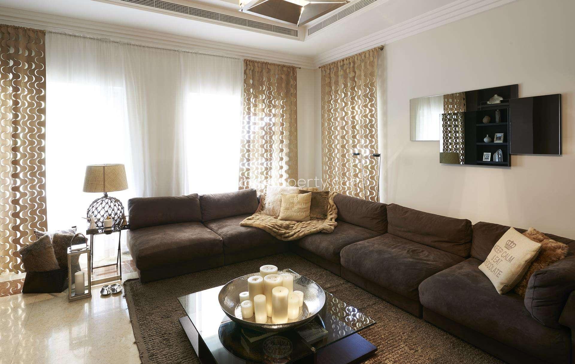 Elegant living room in Hattan L2 Villa, Arabian Ranches, featuring modern decor and plush seating