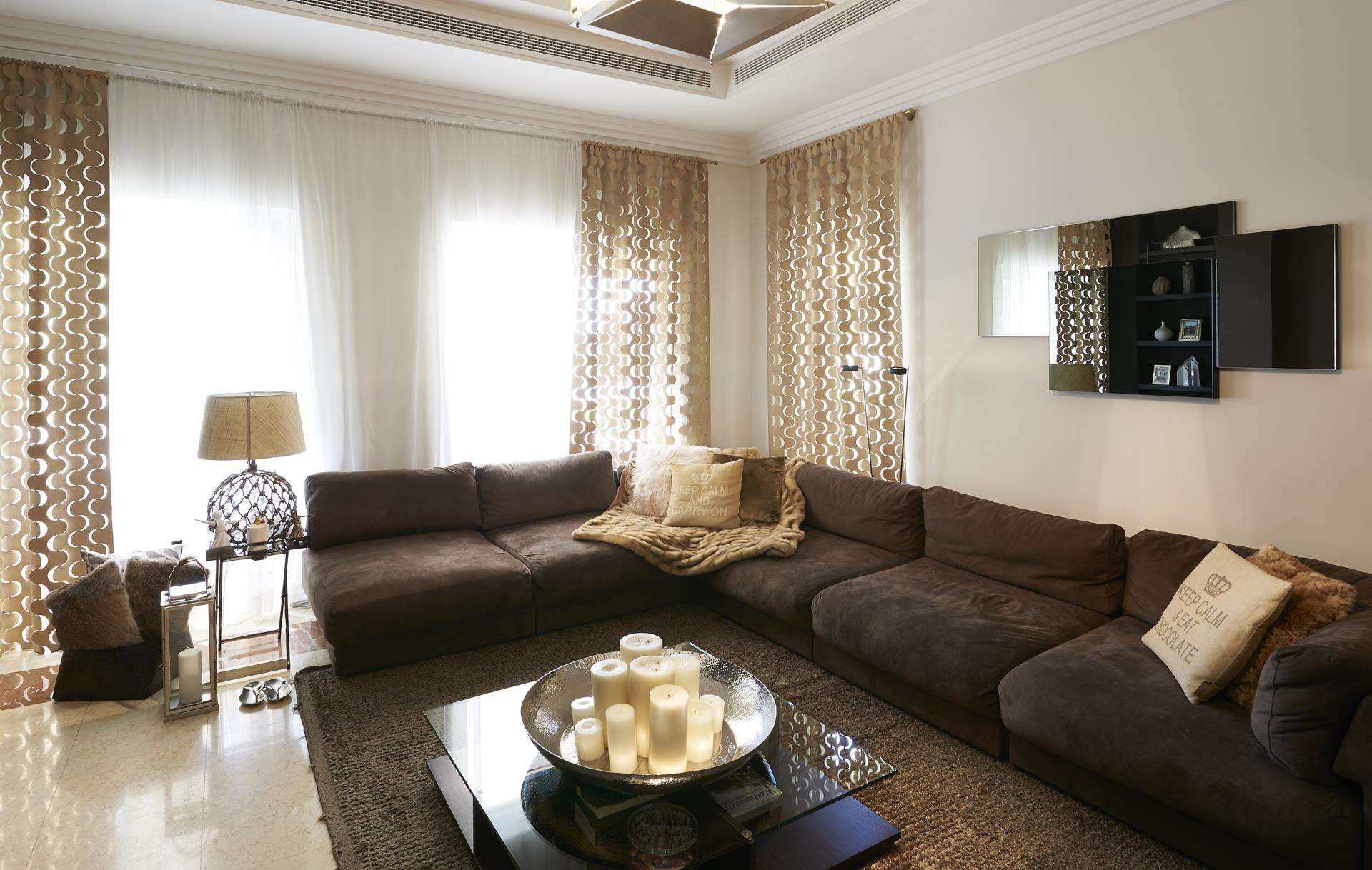 Elegant living room in Hattan L2 Villa, Arabian Ranches, featuring modern decor and plush seating