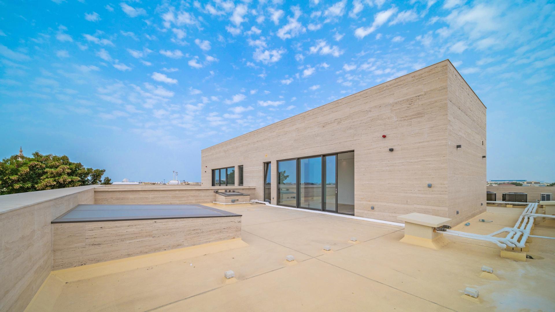 Spacious villa interior with large windows, natural light, and wooden flooring in Jumeirah 2