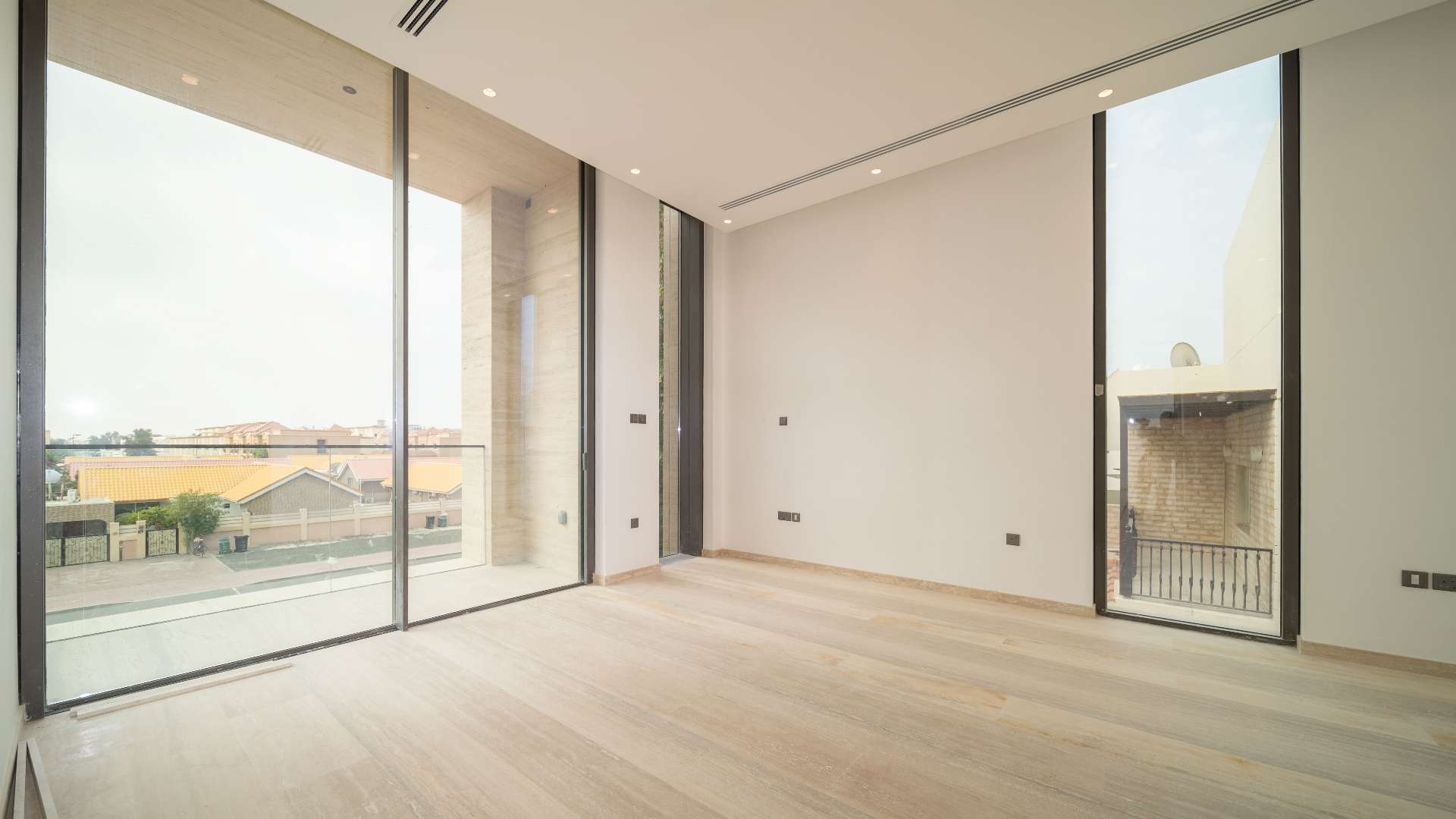 Modern villa exterior in Jumeirah 2, Dubai, with large windows and sleek design