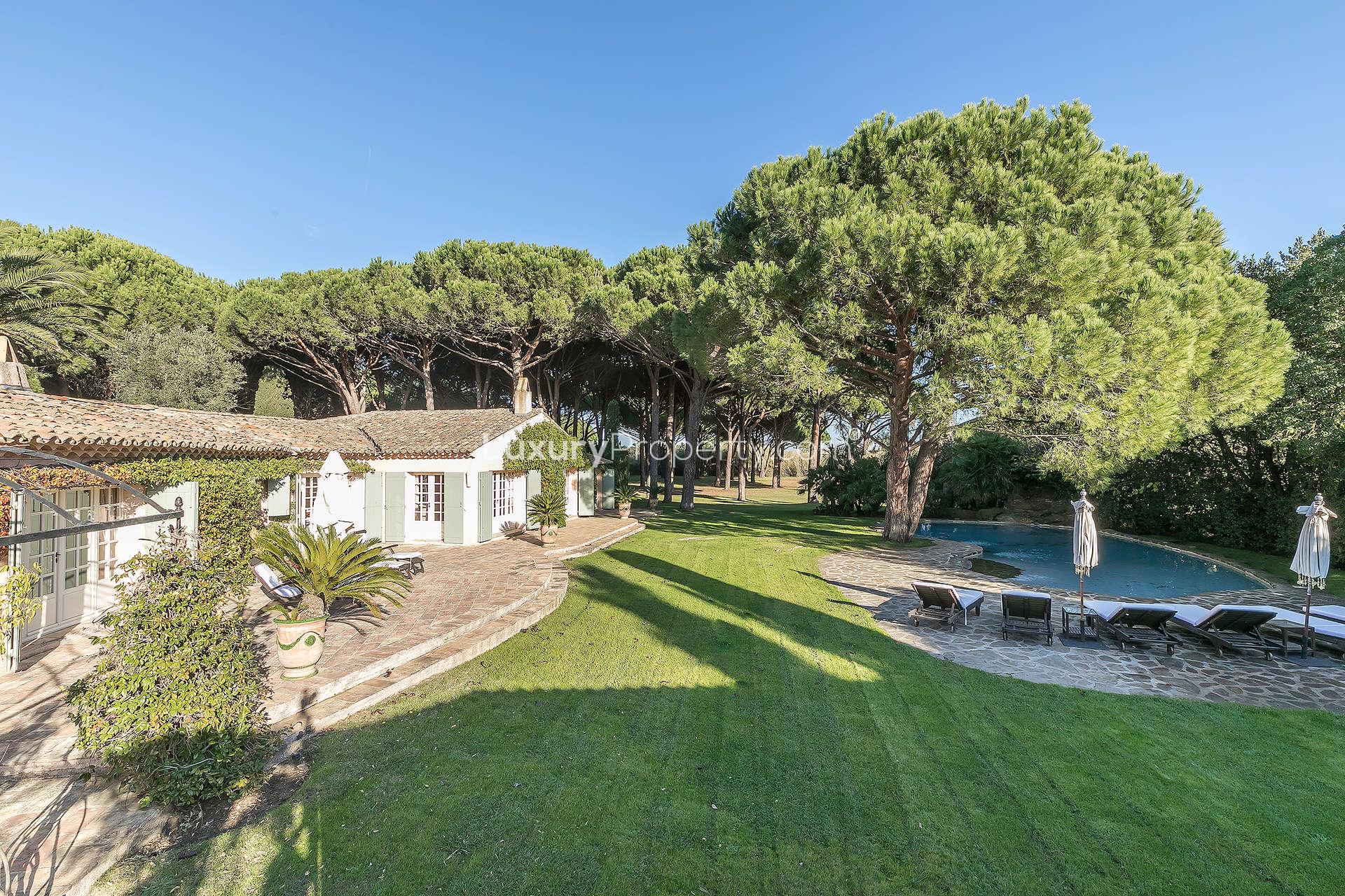 Provencal villa living room with elegant decor, French doors, and garden view in Ramatuelle