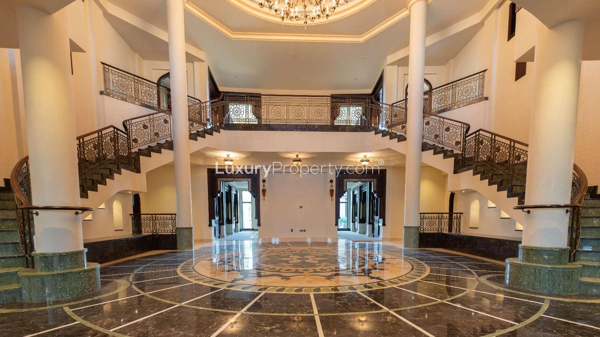 Luxurious entrance of 7-bedroom villa in Emirates Hills, featuring elegant landscaping and architecture