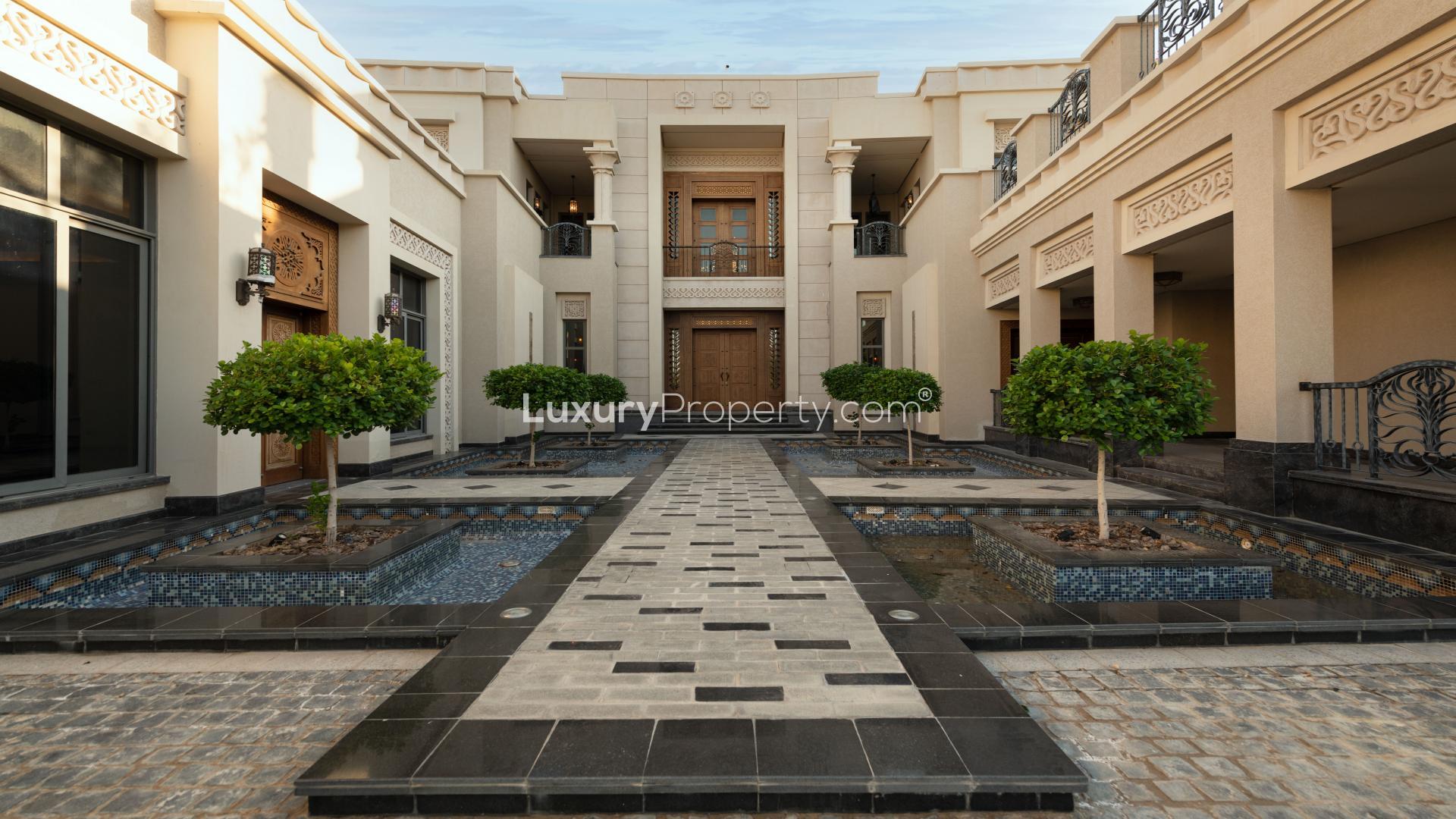 Luxurious 7-bedroom villa entrance with spacious driveway in Emirates Hills, Sector L