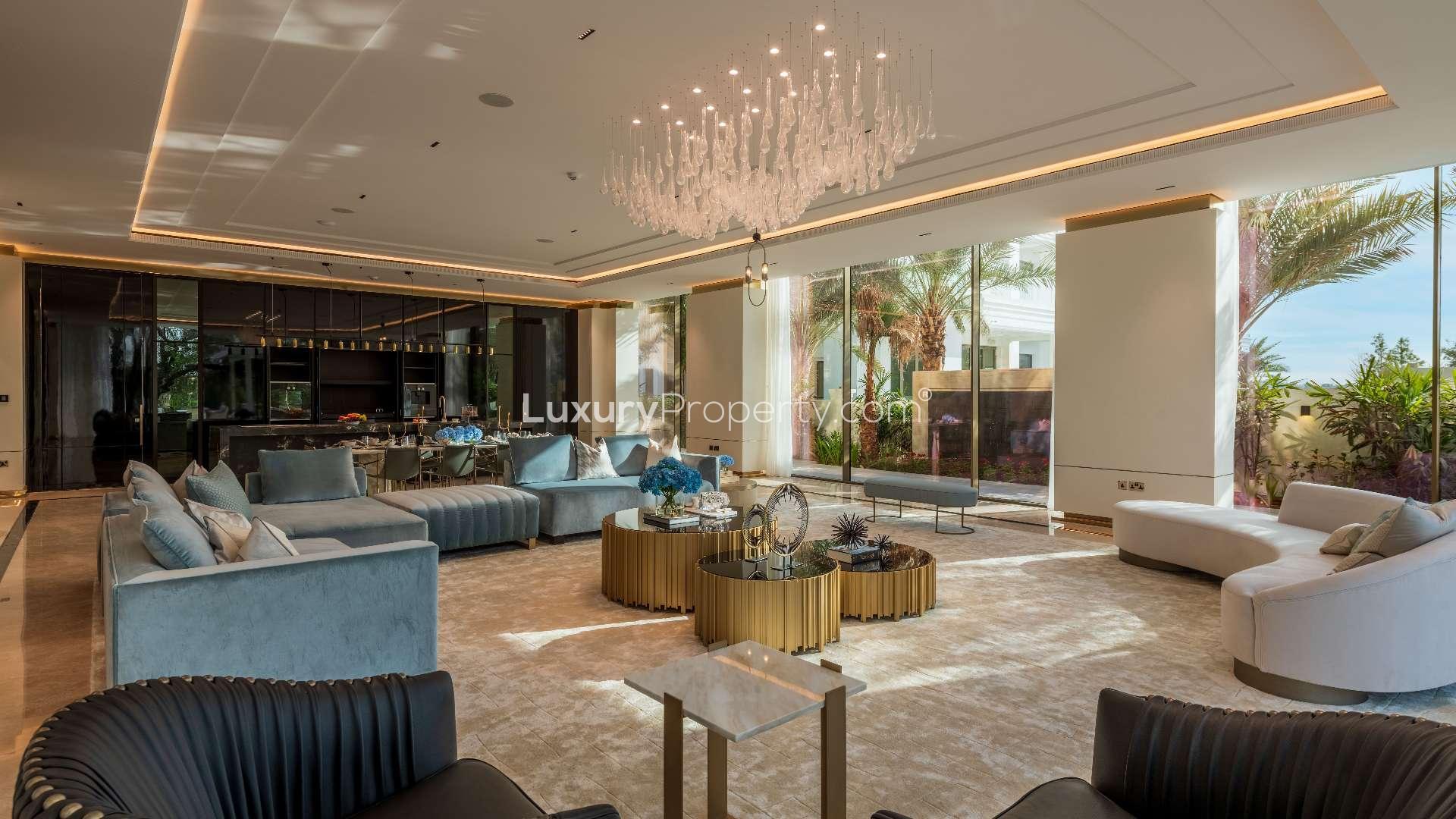 Luxurious living room in 7-bedroom villa, Emirates Hills, featuring elegant decor and chandelier