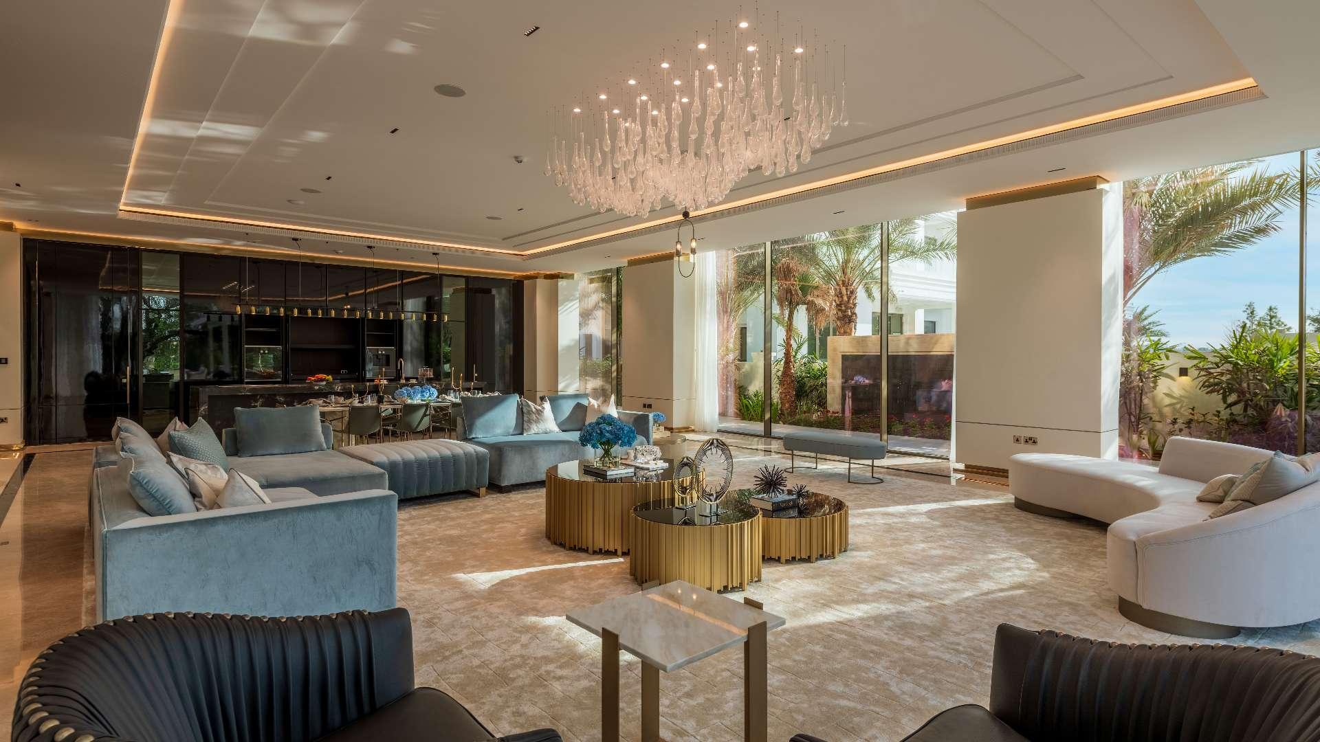 Luxurious living room in 7-bedroom villa, Emirates Hills, featuring elegant decor and chandelier
