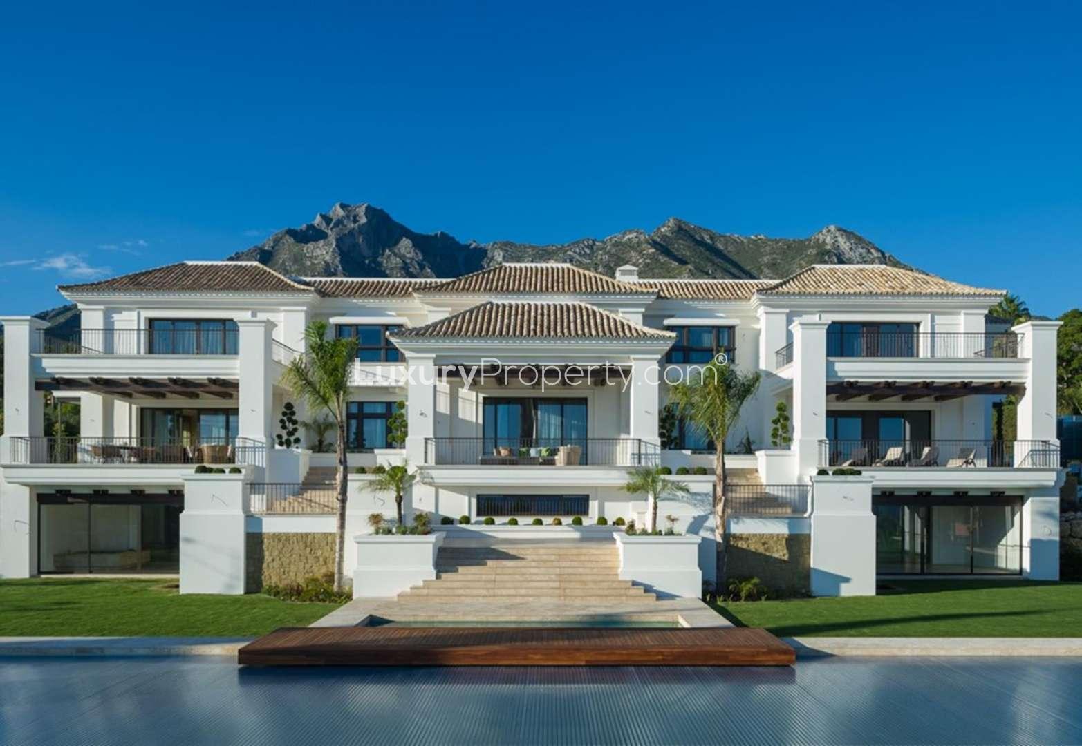 Elegant living room in Marbella villa for sale, featuring plush seating and large windows