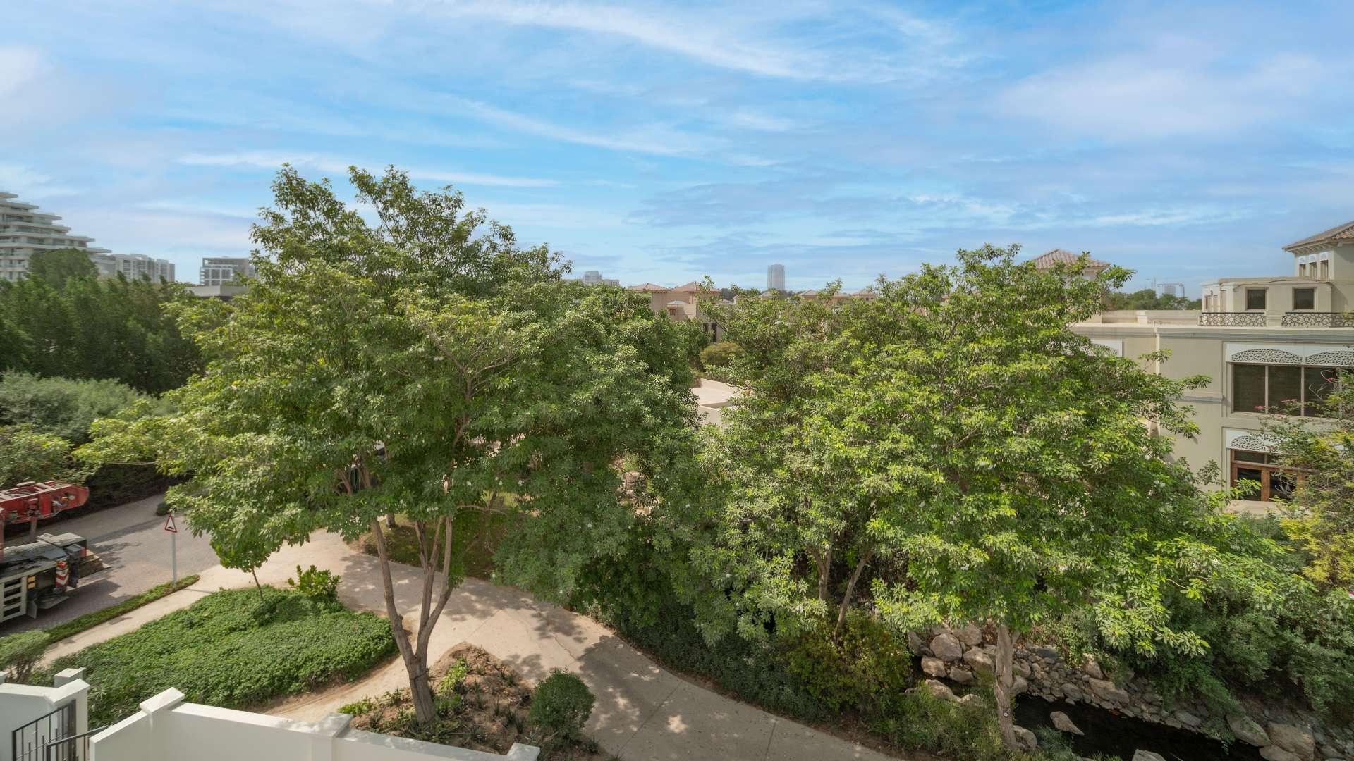 Luxurious living room in Al Barari 7-bedroom villa with modern decor and elegant furnishings