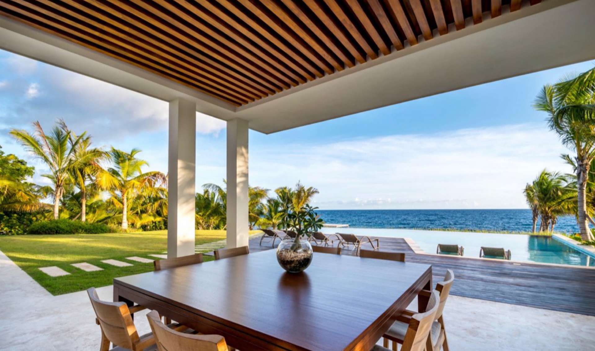 Outdoor dining area with ocean view at Casa de Campo villa in La Romana