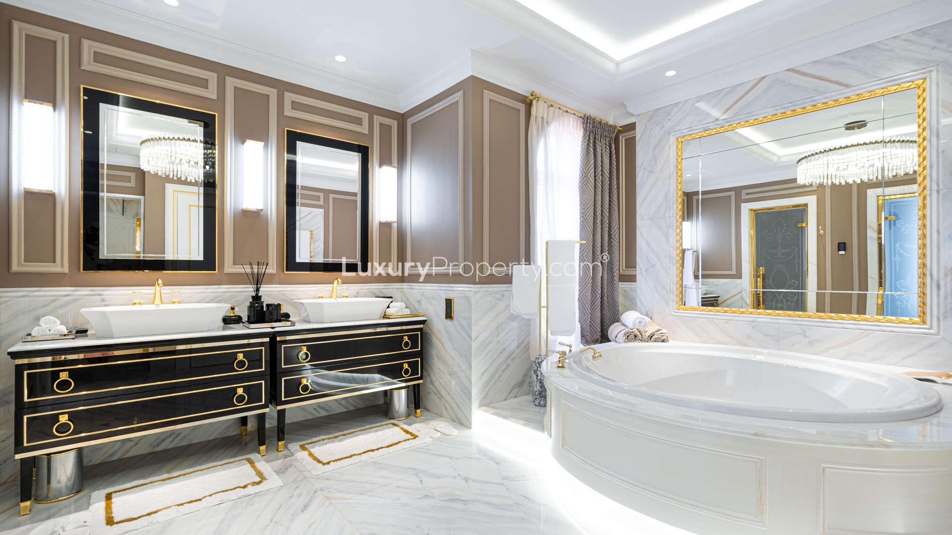 Luxurious bedroom in seven-bedroom villa at XXII Carat, Palm Jumeirah, with balcony view