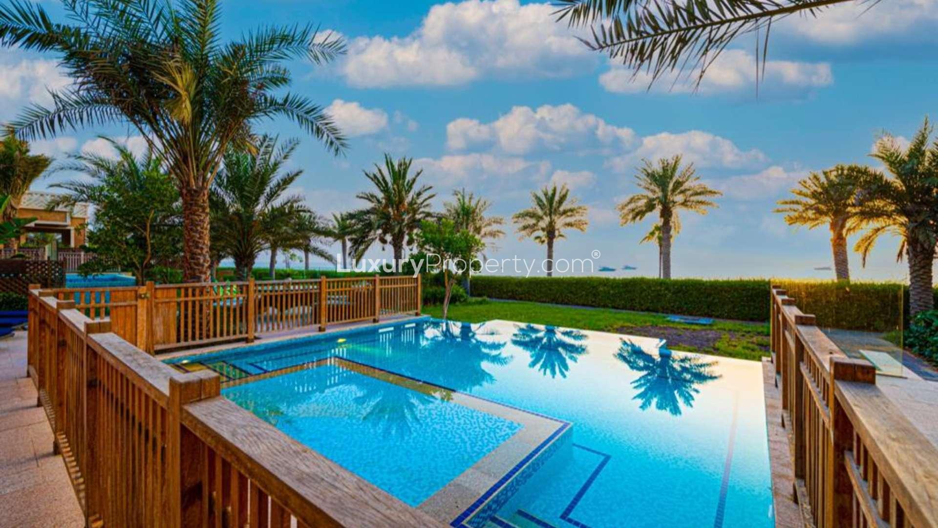 Outdoor patio of luxury villa in Kingdom of Sheba, Palm Jumeirah with seating and loungers