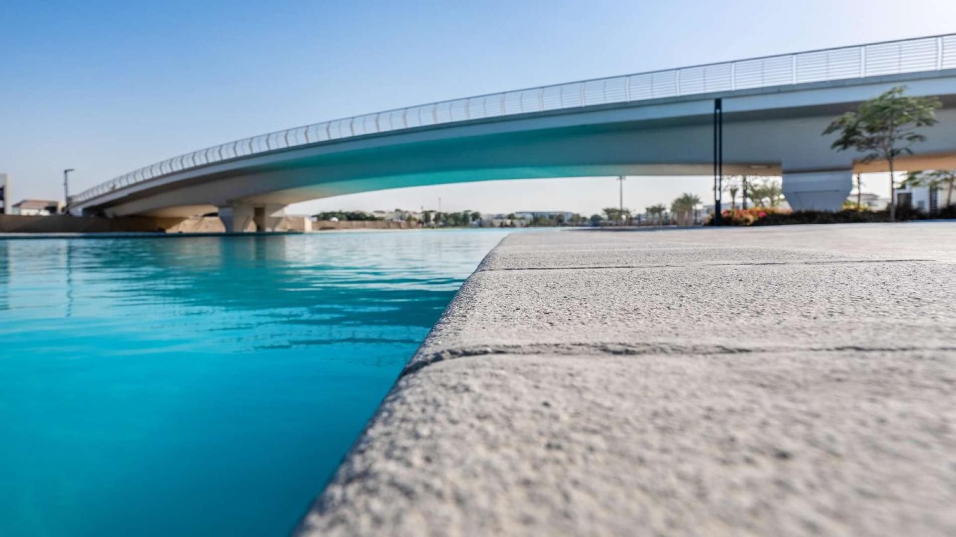 Contemporary kitchen with wooden cabinets in District One Mansions villa, Mohammed Bin Rashid City