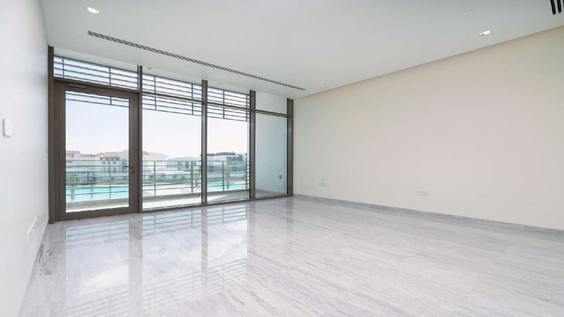 Modern interior of luxury villa in District One, featuring glass staircase and marble flooring