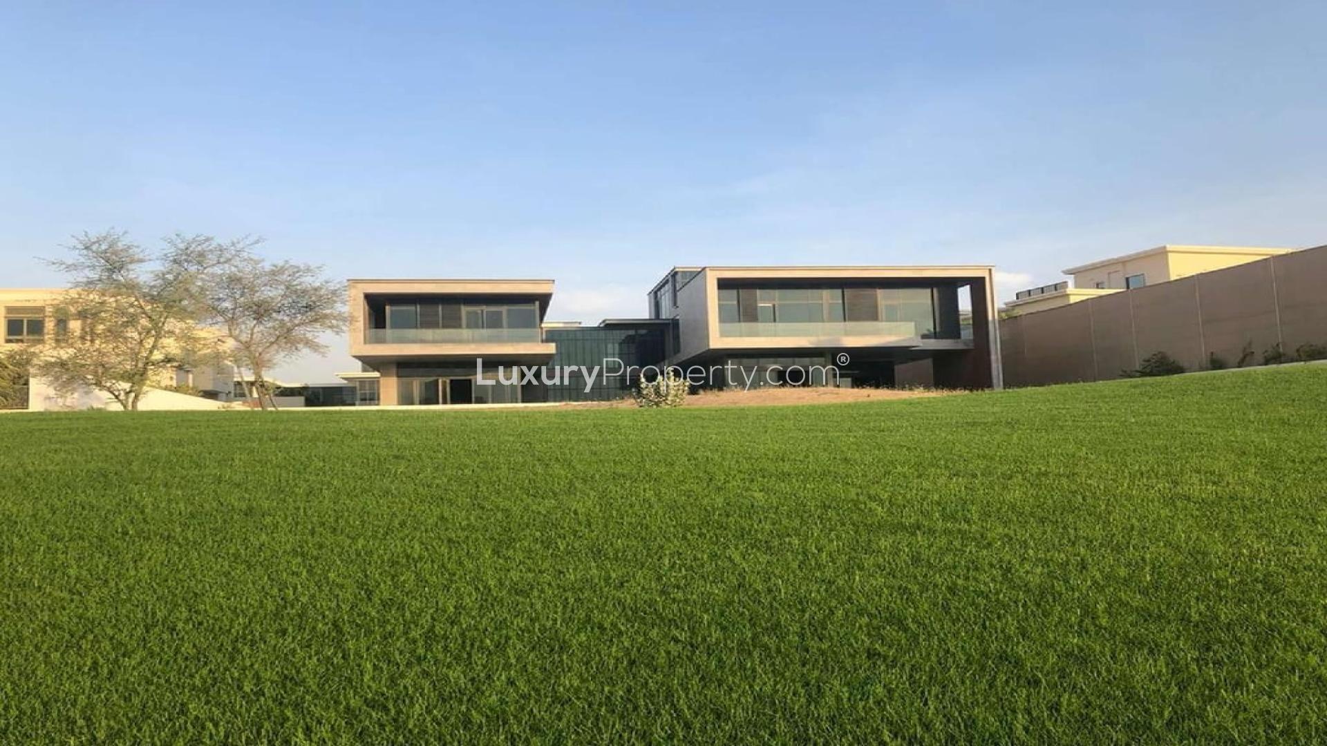 Modern 8-bedroom villa exterior in Dubai Hills Grove, lush green lawn in foreground