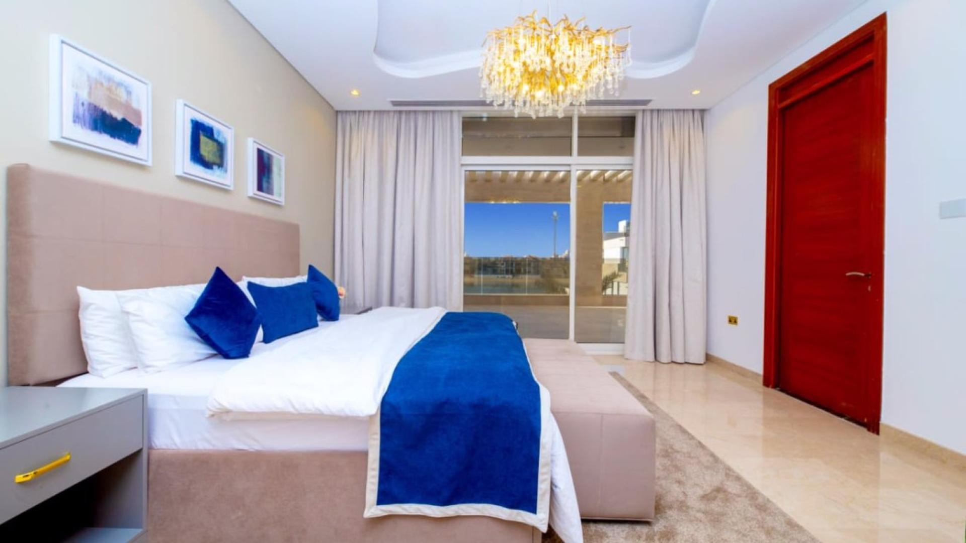 Luxurious villa poolside view with loungers, overlooking private beach on Palm Jumeirah