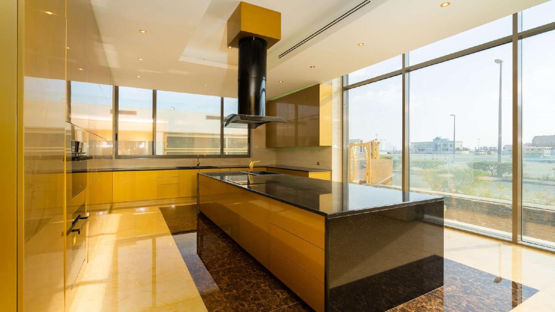 Alt text: "Stunning night view from Pearl Jumeirah villa, showcasing Burj Khalifa and city skyline.",Luxurious modern kitchen in Pearl Jumeirah villa with spacious design and ample natural light