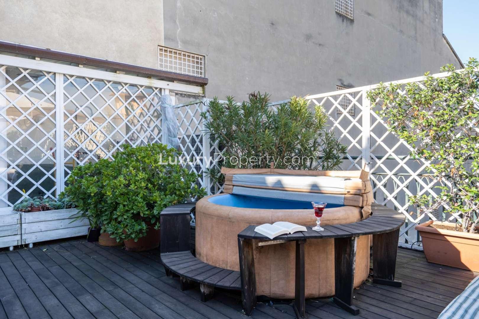 Outdoor terrace with dining area in deluxe Florence penthouse for sale