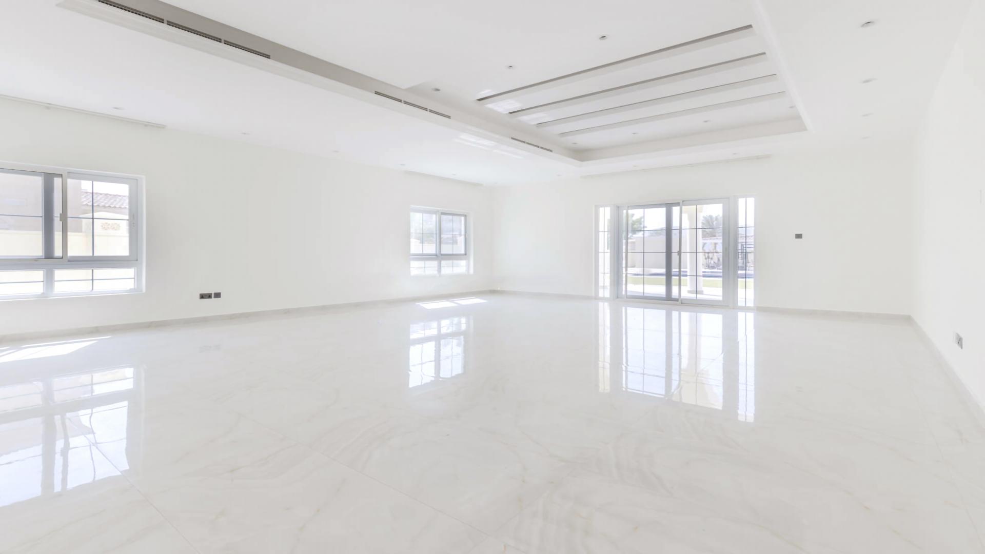 Spacious interior of luxury villa in Arabian Ranches with large windows and marble floors