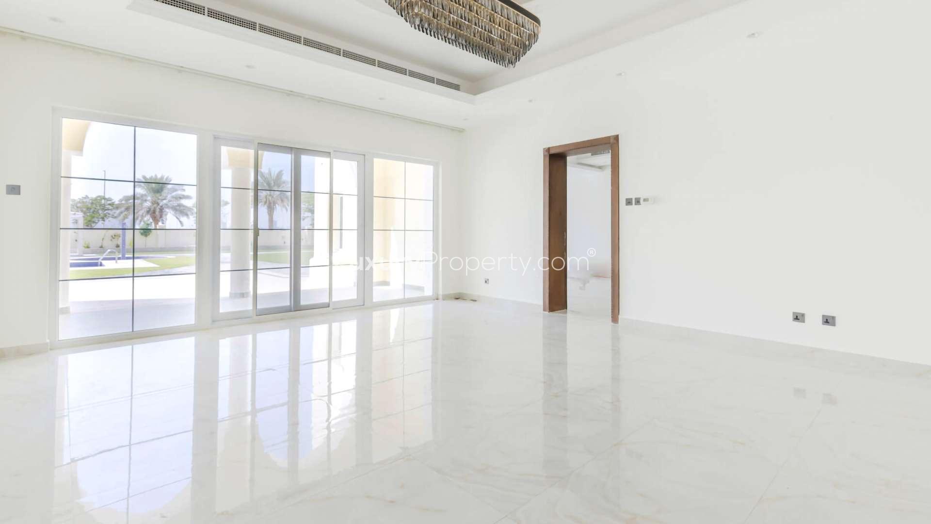 Spacious interior of 8-bed villa in Arabian Ranches, featuring marble floors and large windows