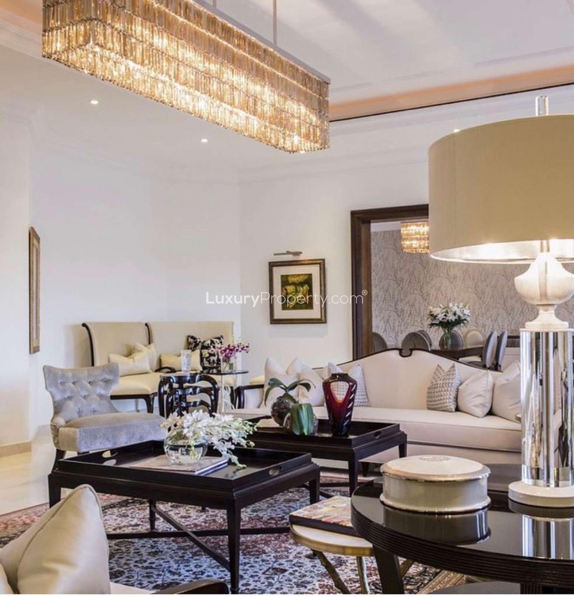 Fully furnished Emirates Hills villa interior with modern decor, hanging chair, and colorful rug