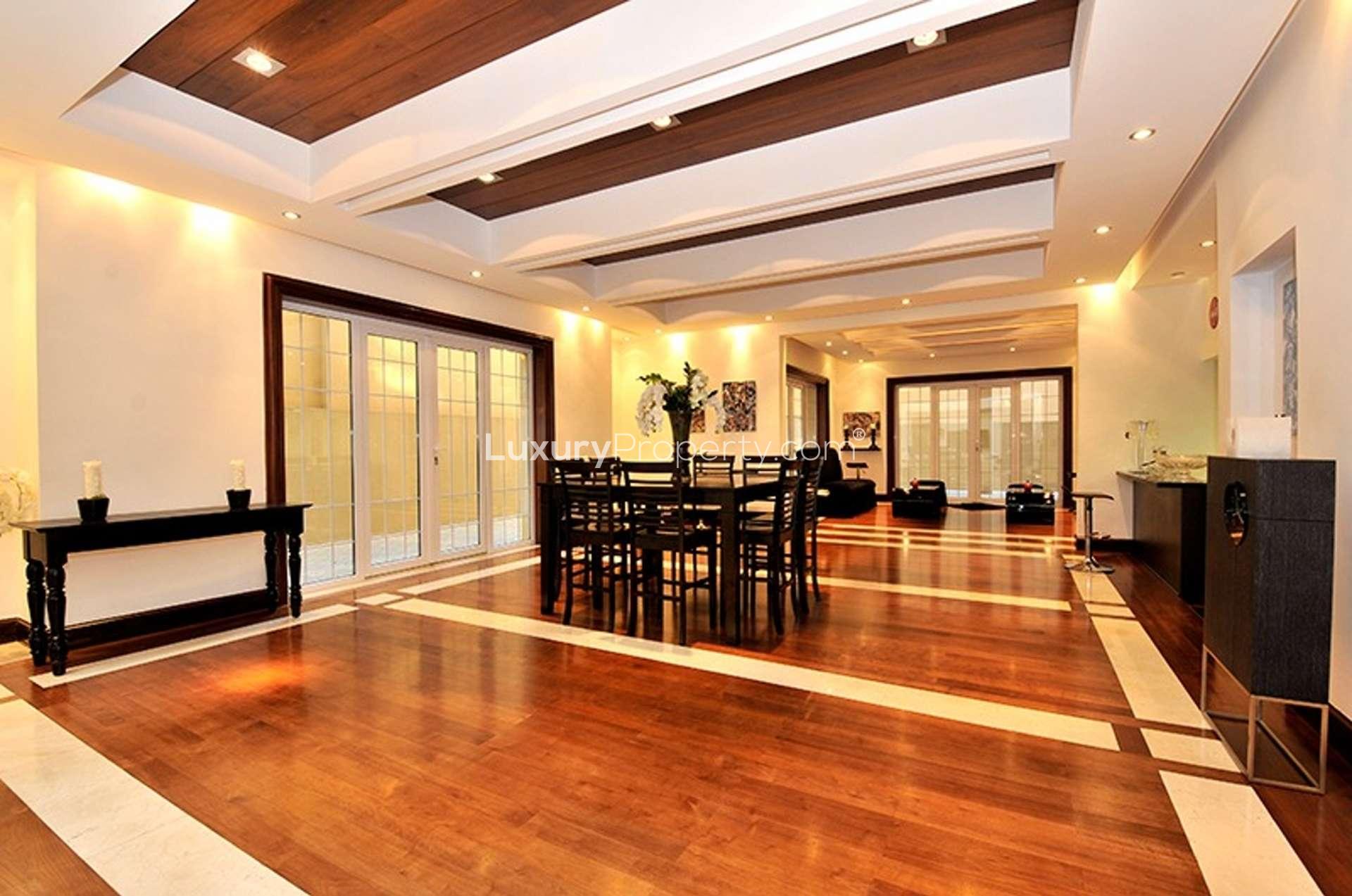 Elegant interior of 8-bedroom villa in Umm Suqeim, Dubai with curved staircase and modern decor