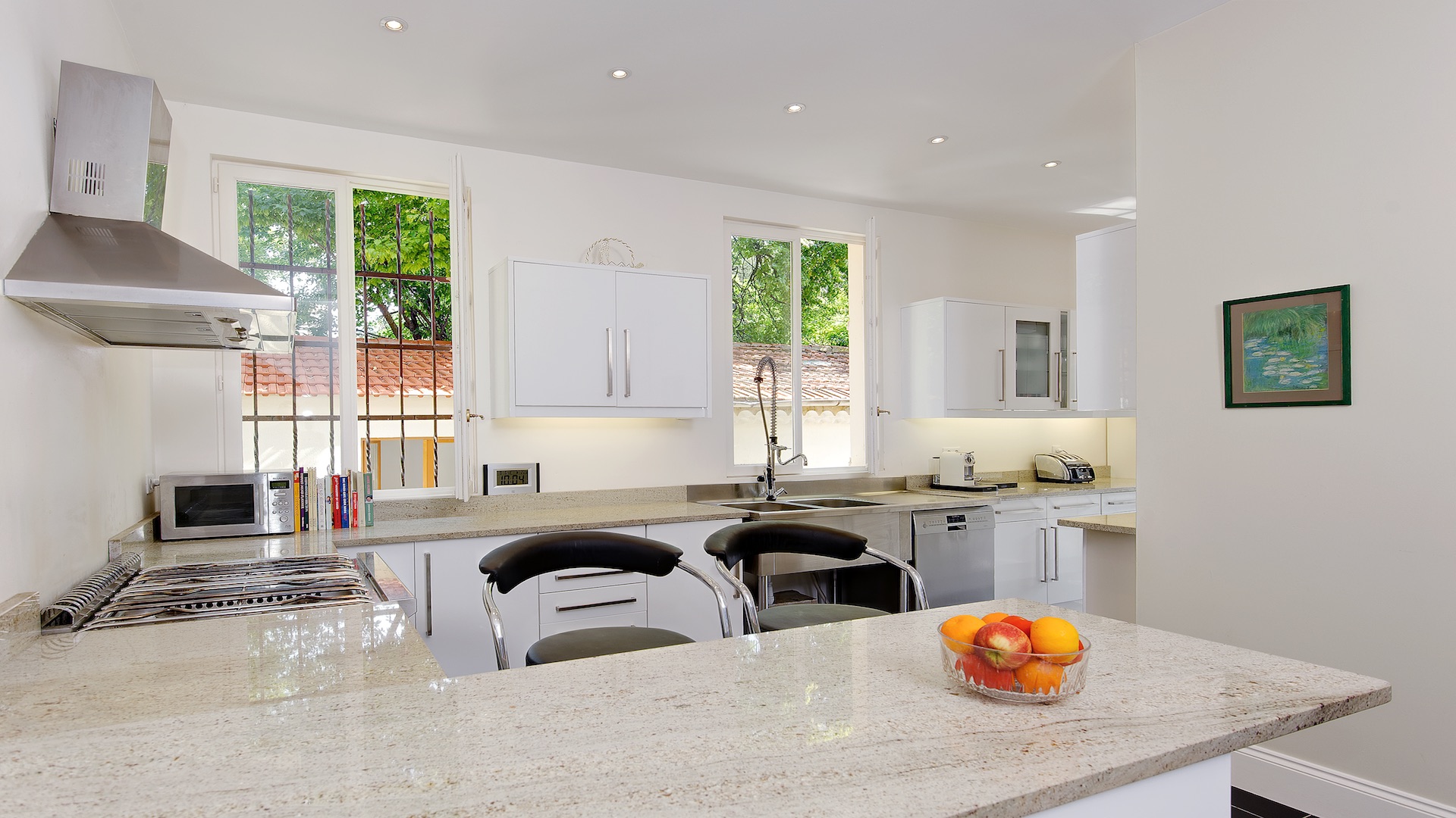Elegant study in luxury villa, Cannes, featuring wooden desk and bookshelves
