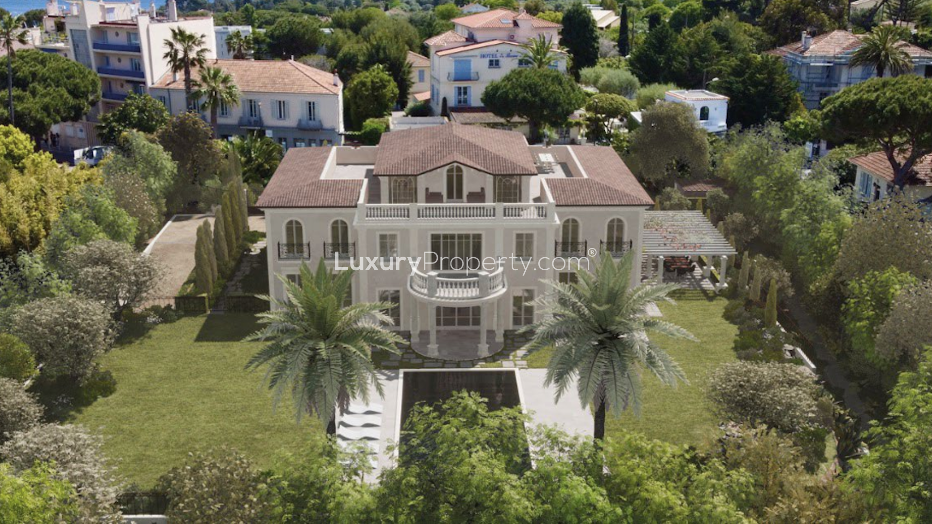 Aerial view of luxury villa in Cap D'Antibes, French Riviera, surrounded by lush greenery