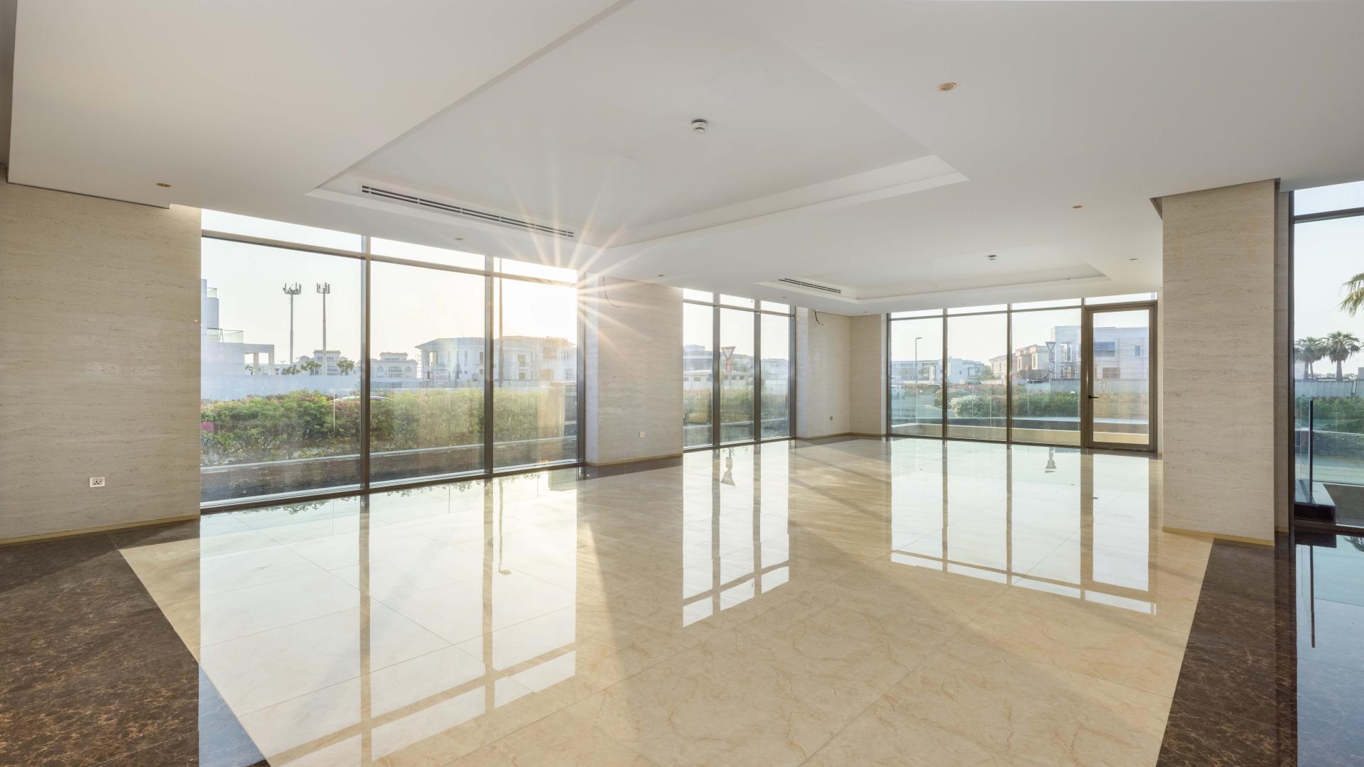 Iconic Pearl Jumeirah villa exterior with modern design and vibrant garden at dusk