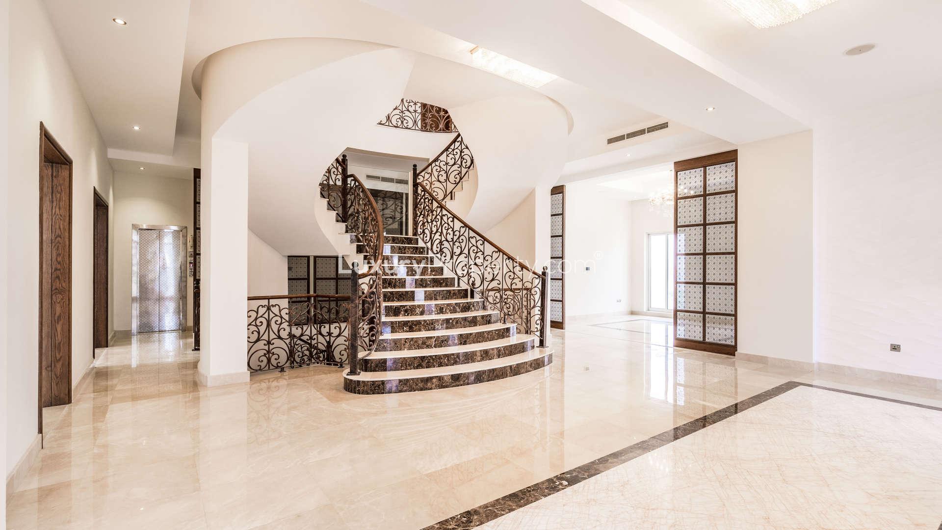 Spacious interior of Pearl Jumeirah villa, featuring elegant marble flooring and ambient lighting