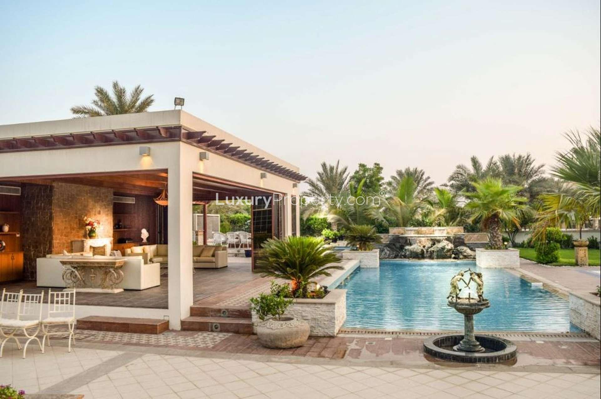 Elegant dining room in 7-bedroom villa, Emirates Hills, featuring chandeliers and luxurious decor