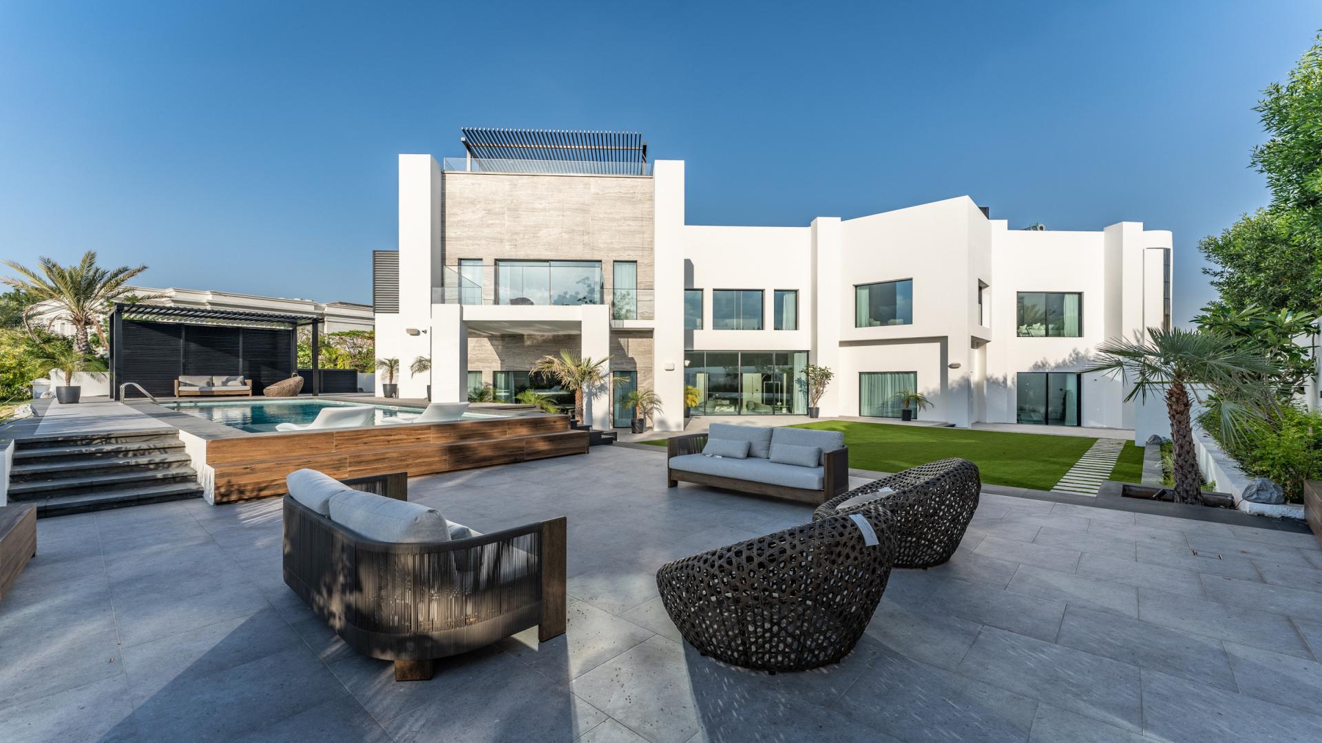 Luxurious dining area in 8-bedroom Emirates Hills villa, featuring elegant modern design and lighting
