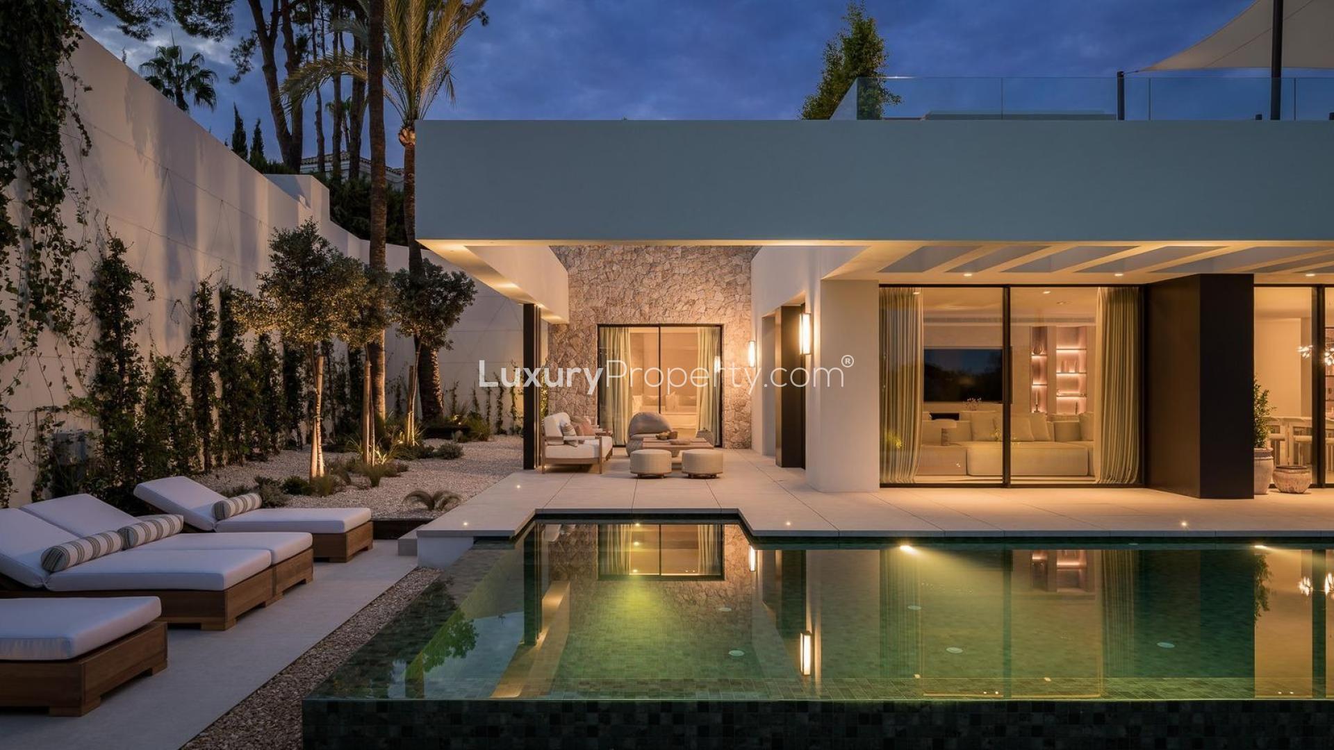 Luxurious villa terrace with pool overlooking golf course in Marbella’s Golf Valley at dusk