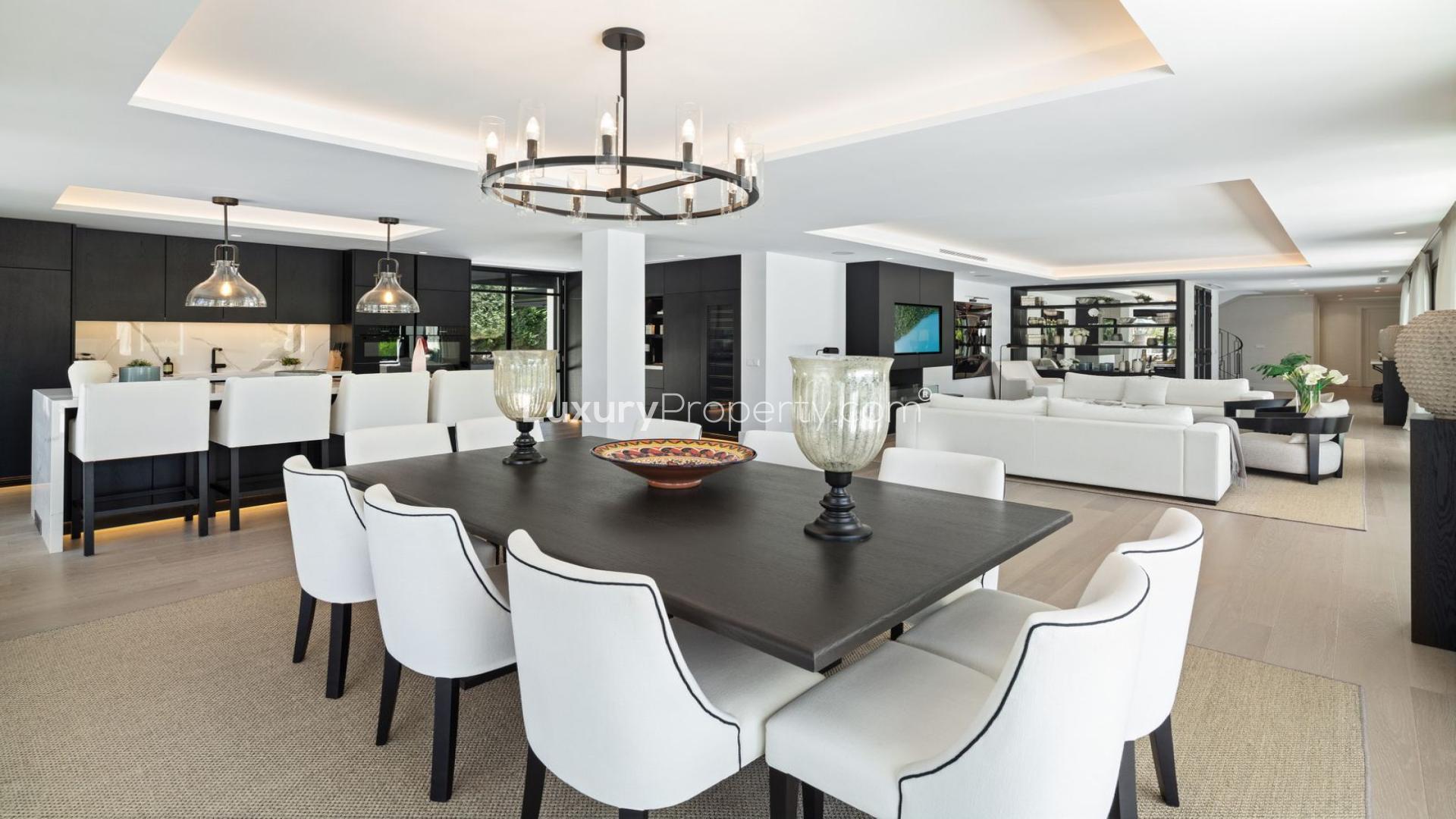 Luxury Marbella villa living room with pool view, elegant seating, and dining area