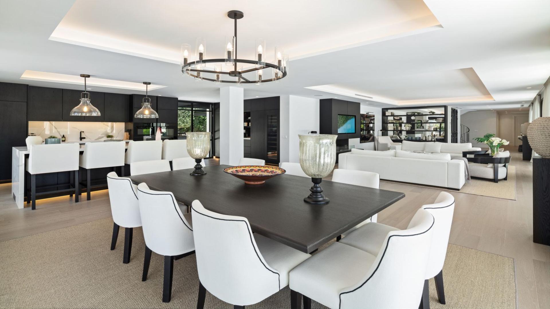 Luxury Marbella villa living room with pool view, elegant seating, and dining area