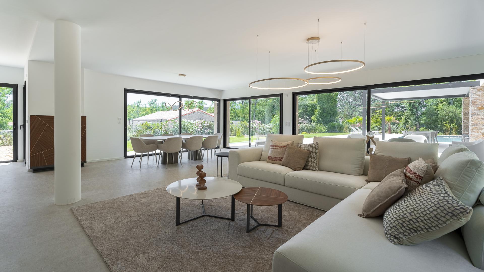 Modern outdoor patio with seating and pool, Domaine de Terre Blanche villa for sale