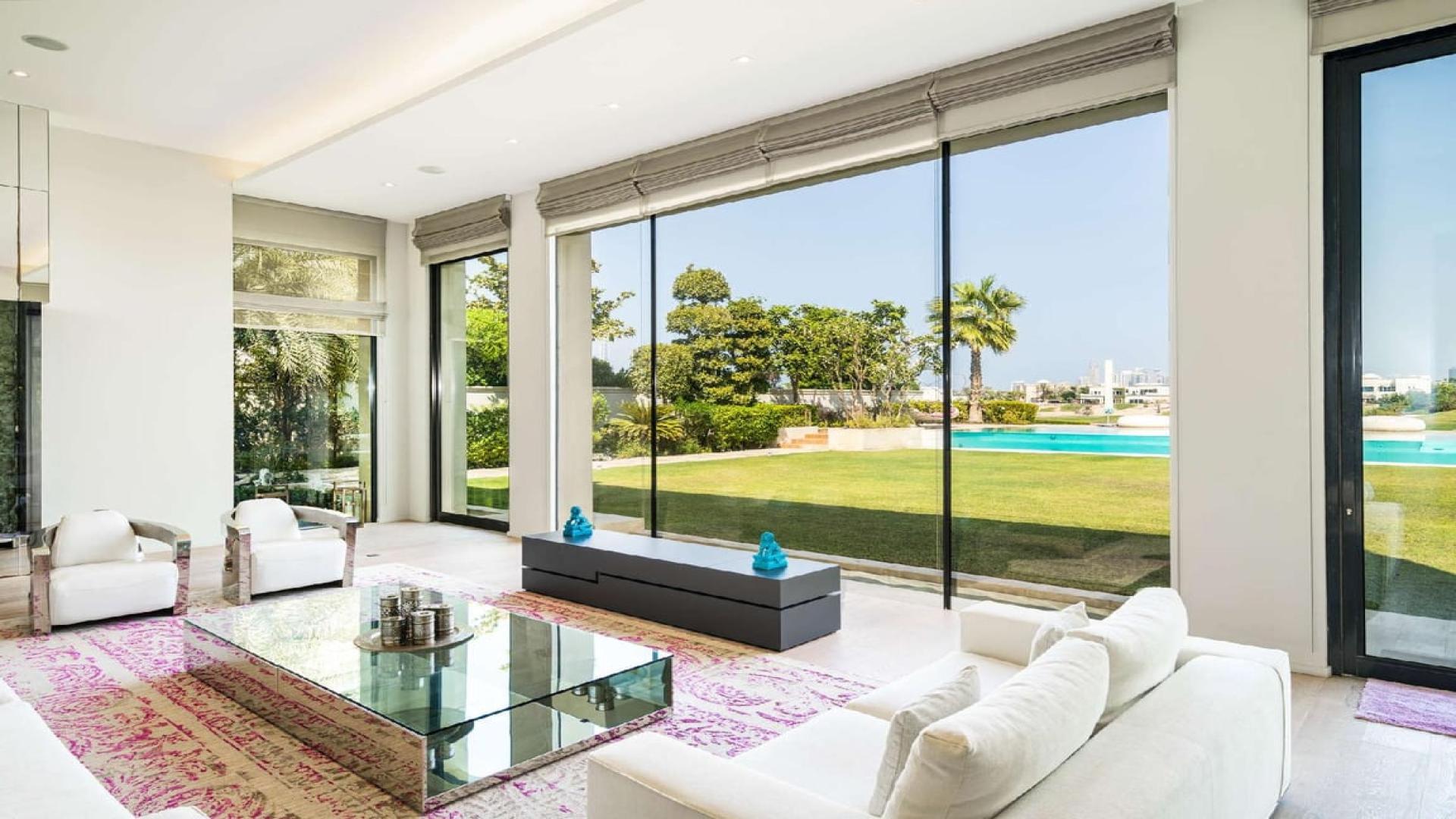 Luxurious villa game room with pool table and garden view in Emirates Hills, Dubai