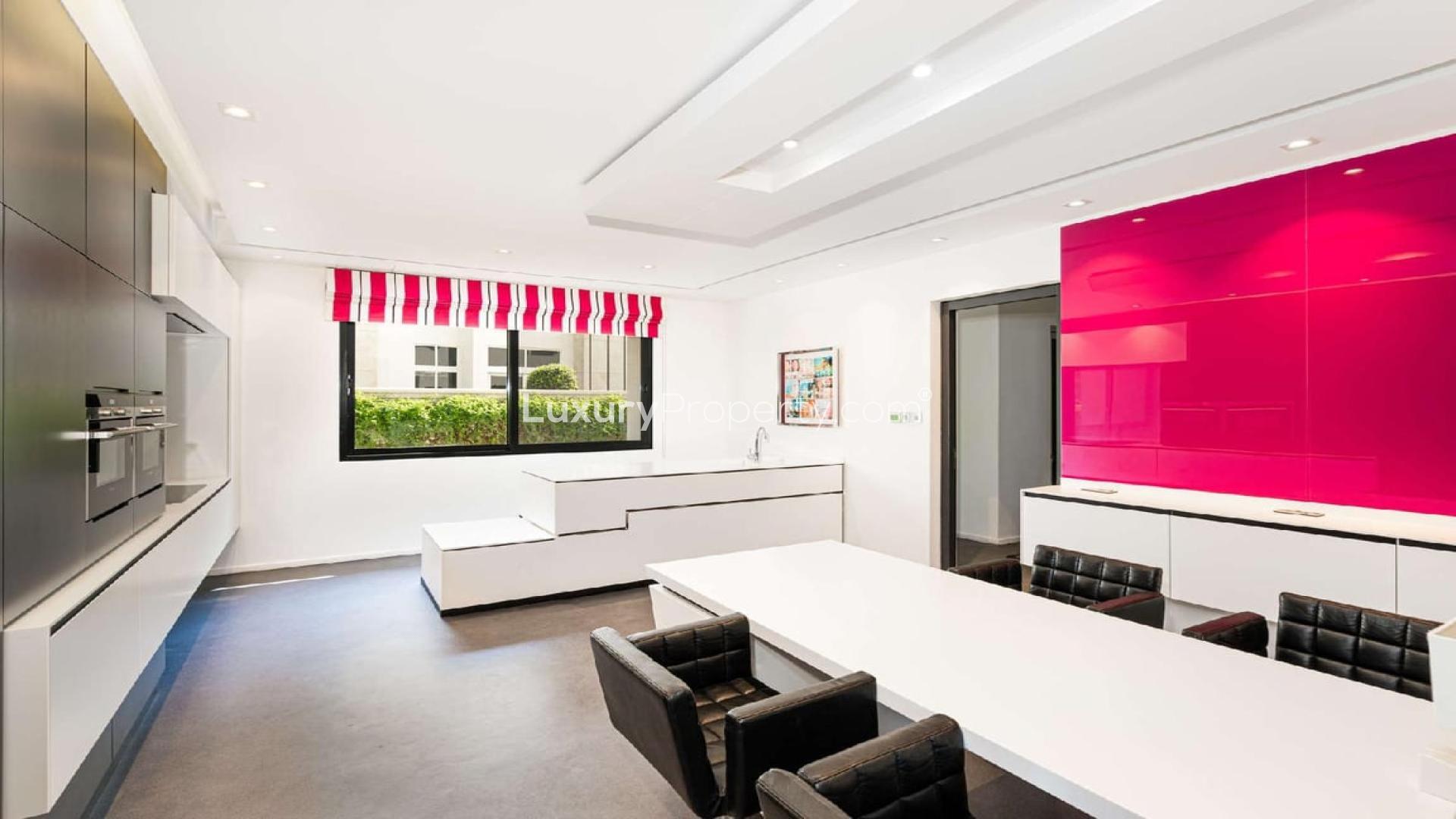 Luxurious Emirates Hills villa living room with purple sofas and golf course views