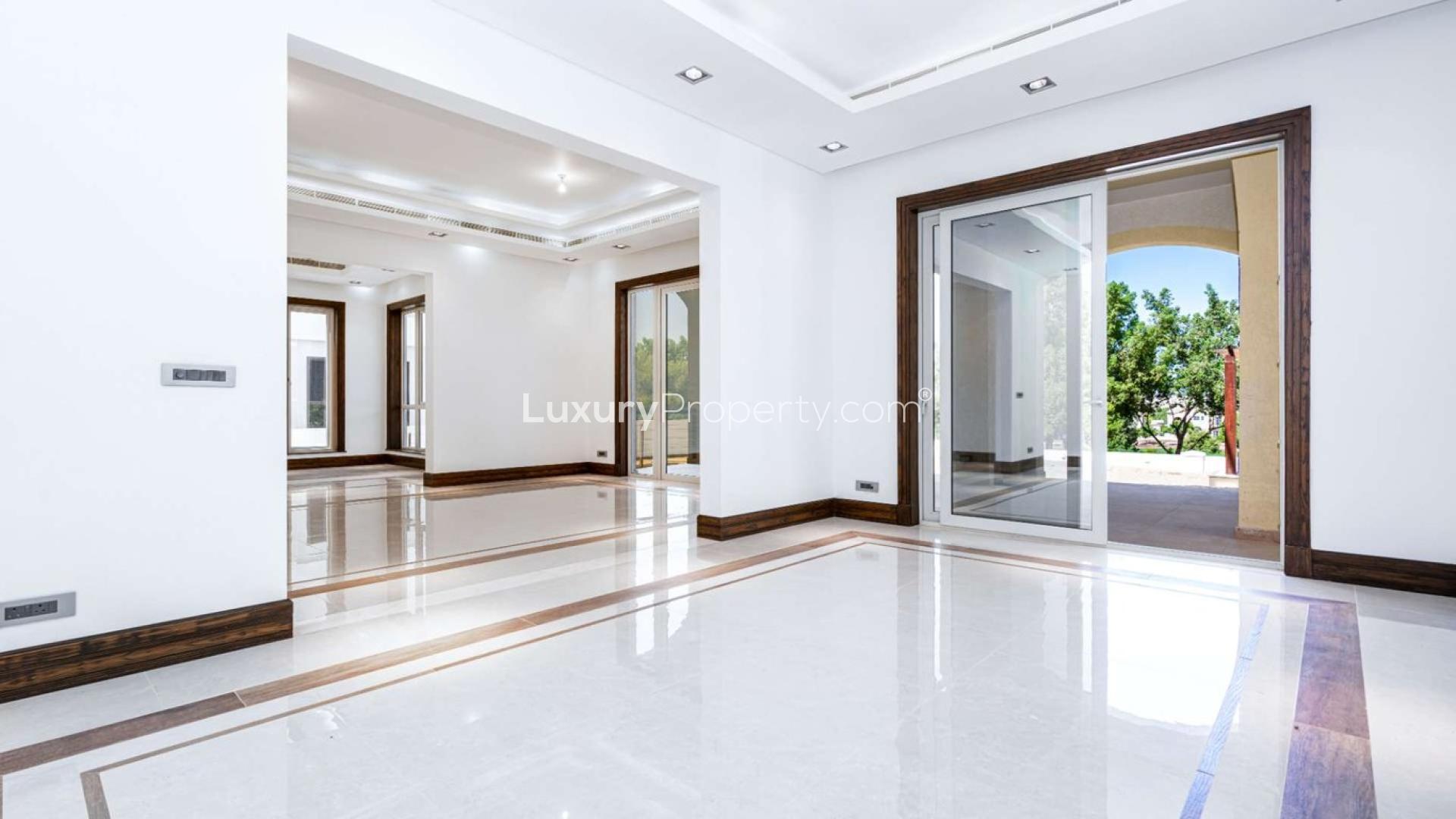 N/A,Spacious interior of Jumeirah Golf Estates villa, featuring elegant finishes and garden view