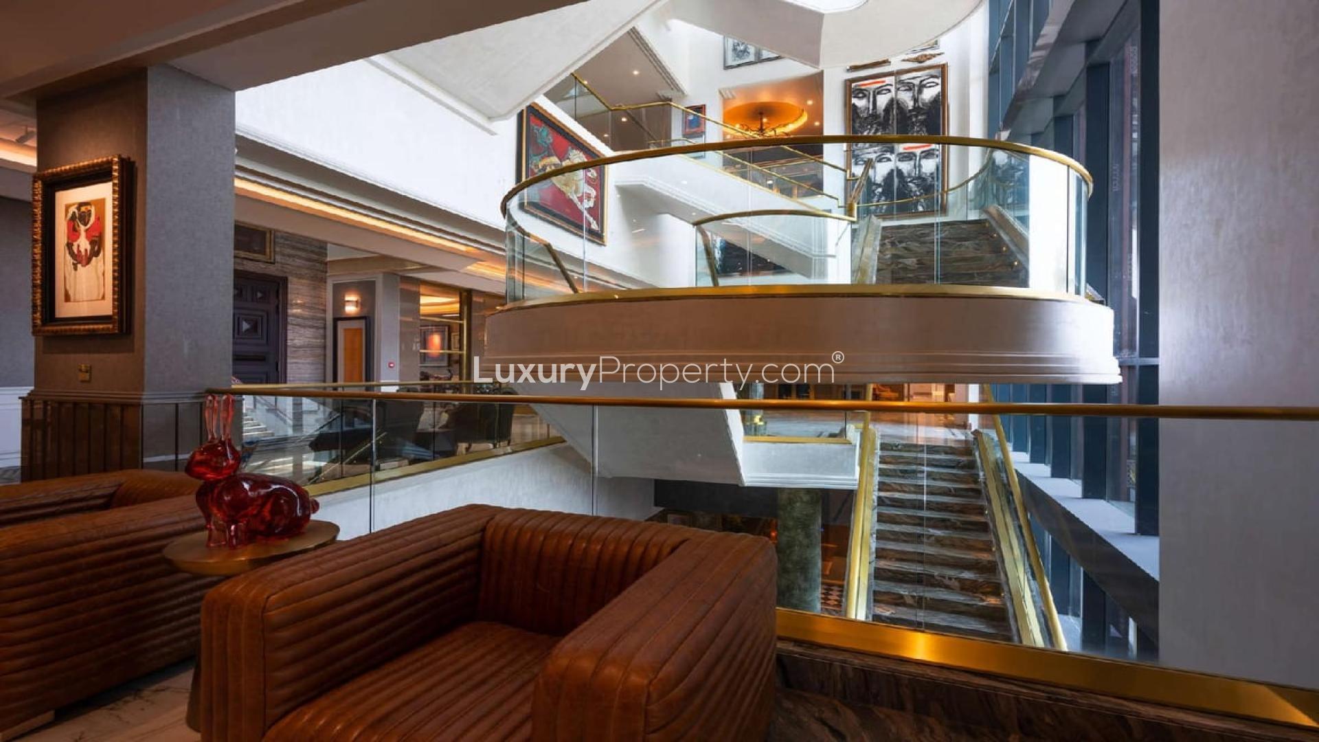 Luxury mansion interior with modern staircase and art in Dubai Hills Estate villa