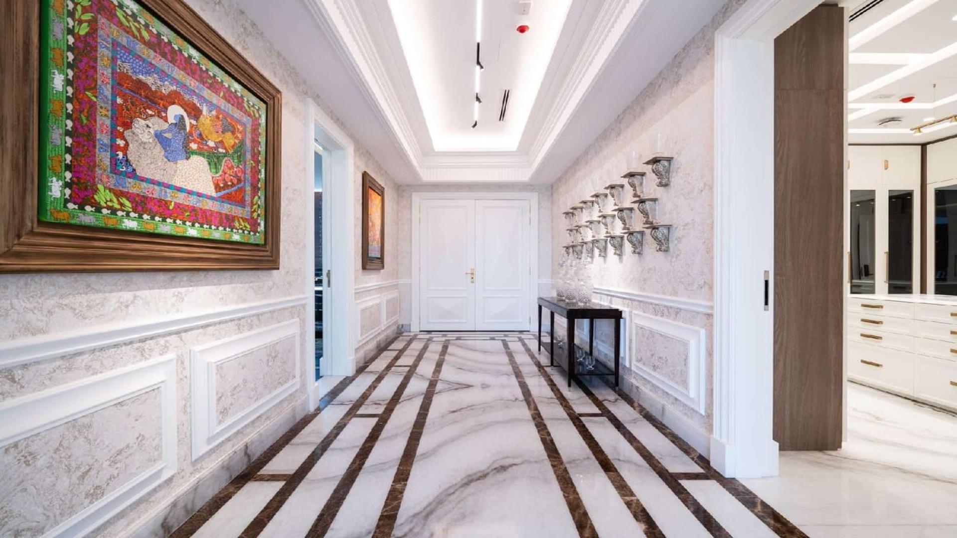 Elegant hallway in luxury Dubai Hills Estate mansion with marble flooring and artistic decor