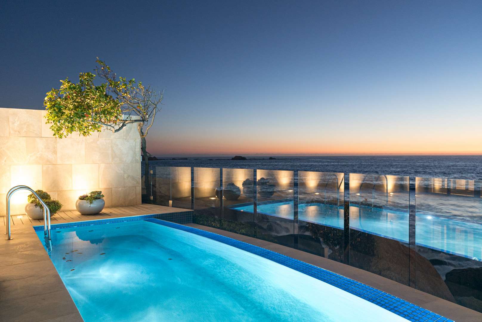 Sunset view from luxury apartment pool in Clifton, Cape Town, beachfront property for sale