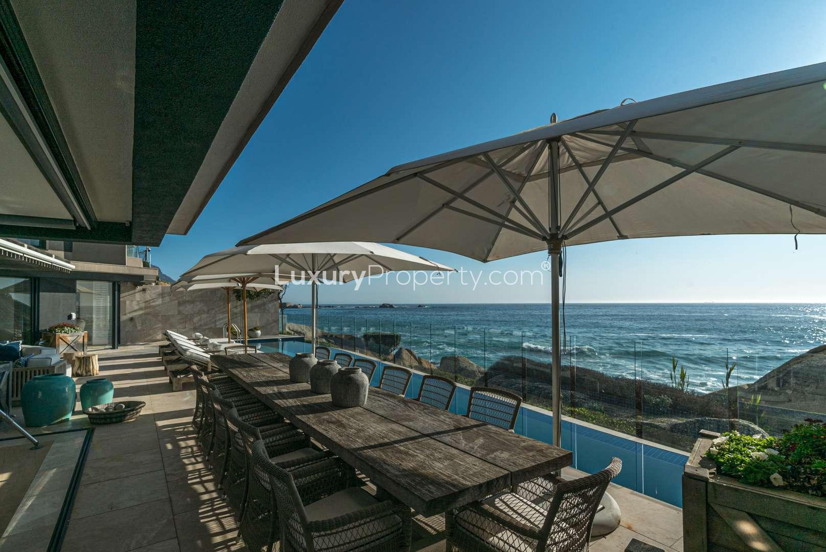 Luxurious Clifton apartment living room with ocean view at sunset, Cape Town