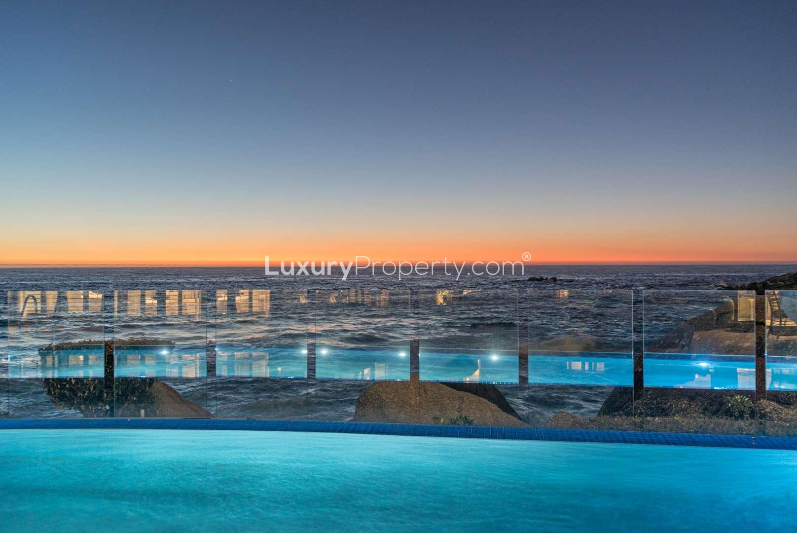 Luxurious oceanfront terrace with dining table and umbrellas, Clifton apartment for sale