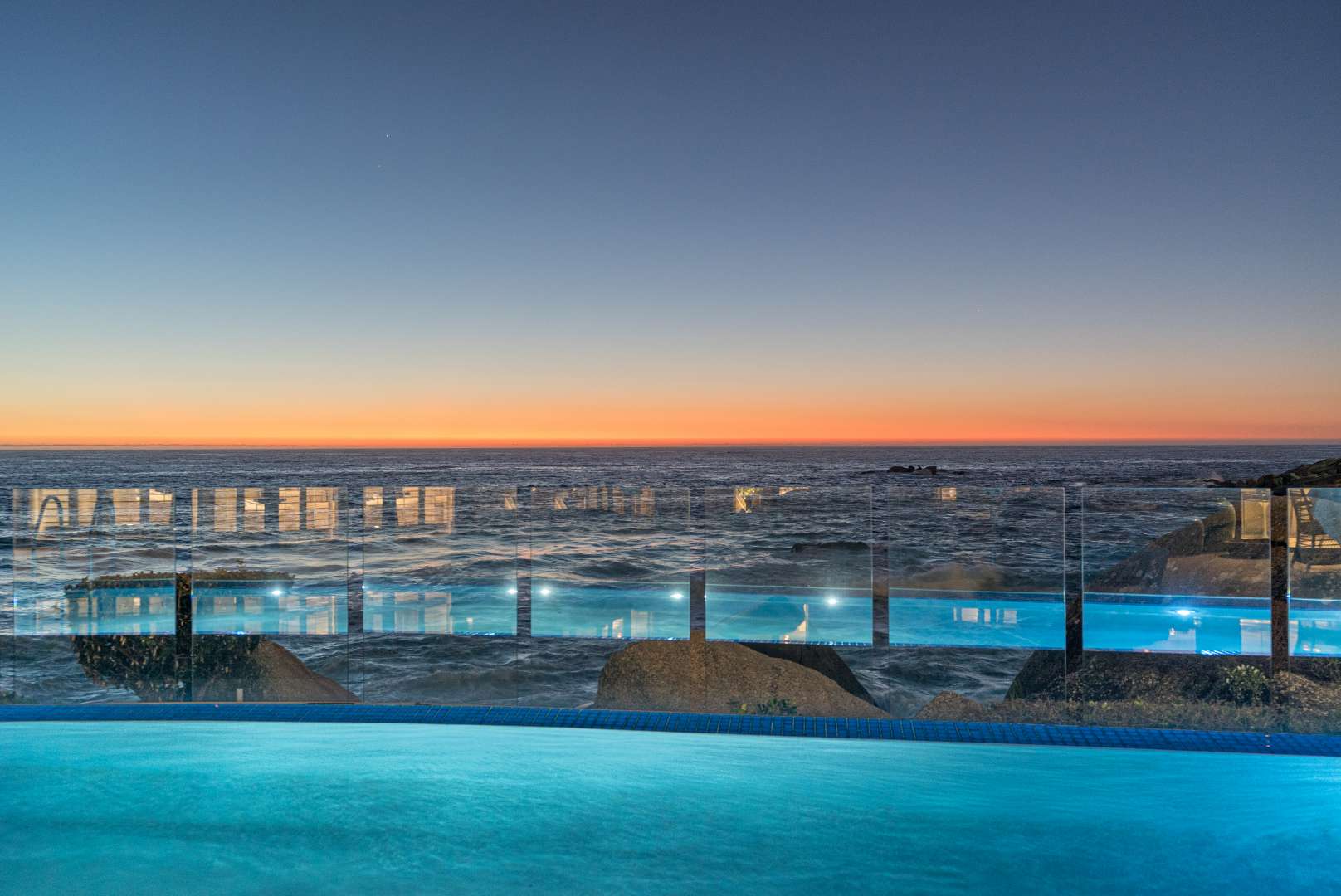 Luxurious oceanfront terrace with dining table and umbrellas, Clifton apartment for sale