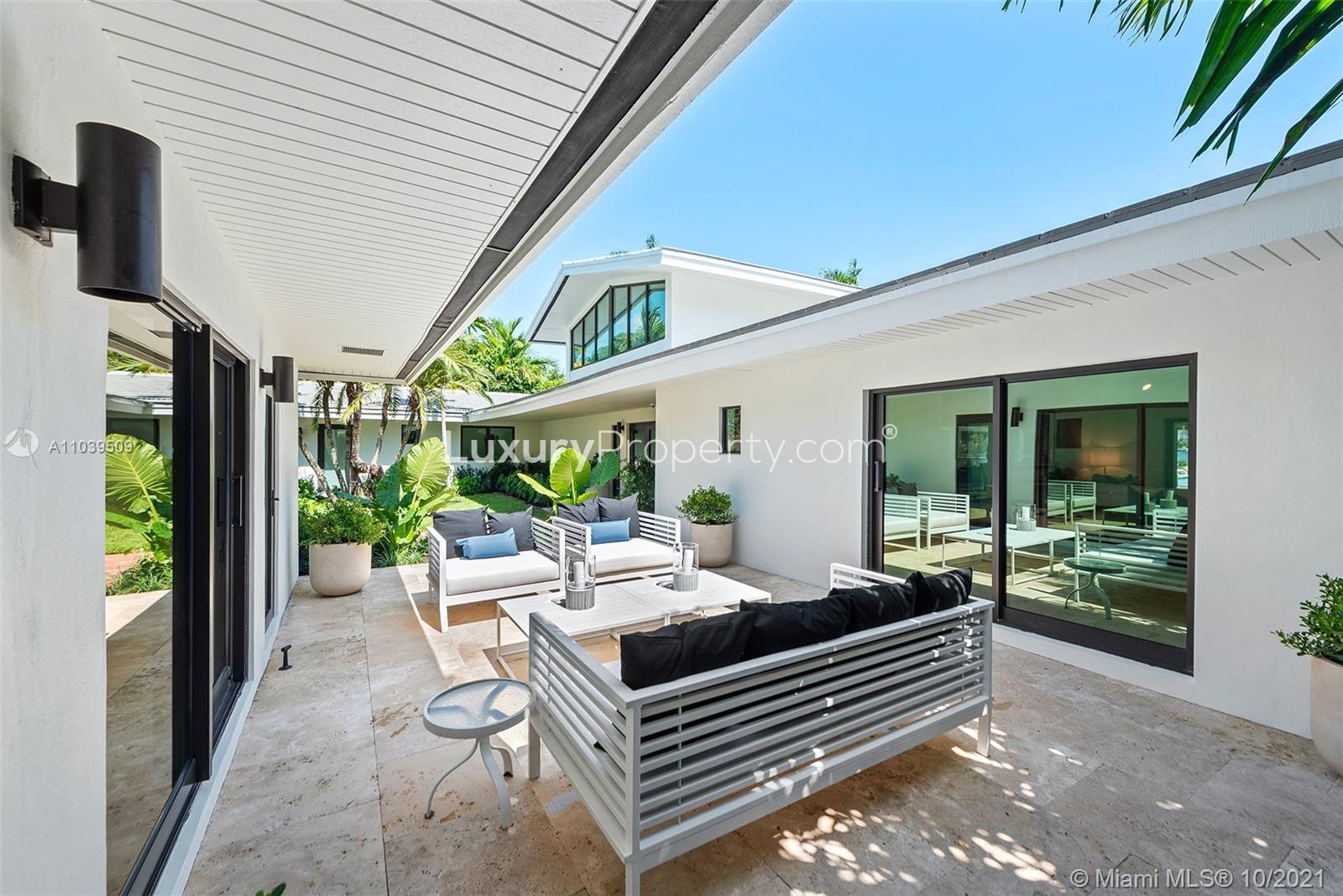 Spacious nine-bed Miami Beach condominium with pool, lush garden, and modern design