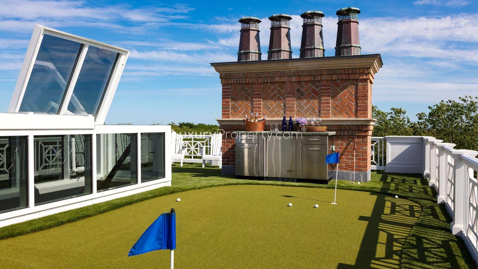 Luxury villa exterior in Hamptons, New York, with elegant architecture and manicured lawns